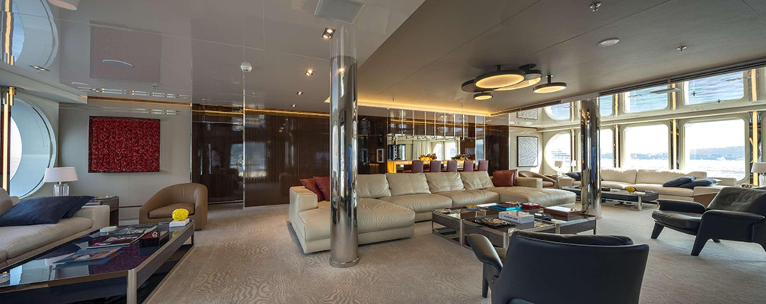 a large living room with a large glass window aboard SERENITY Yacht for Charter