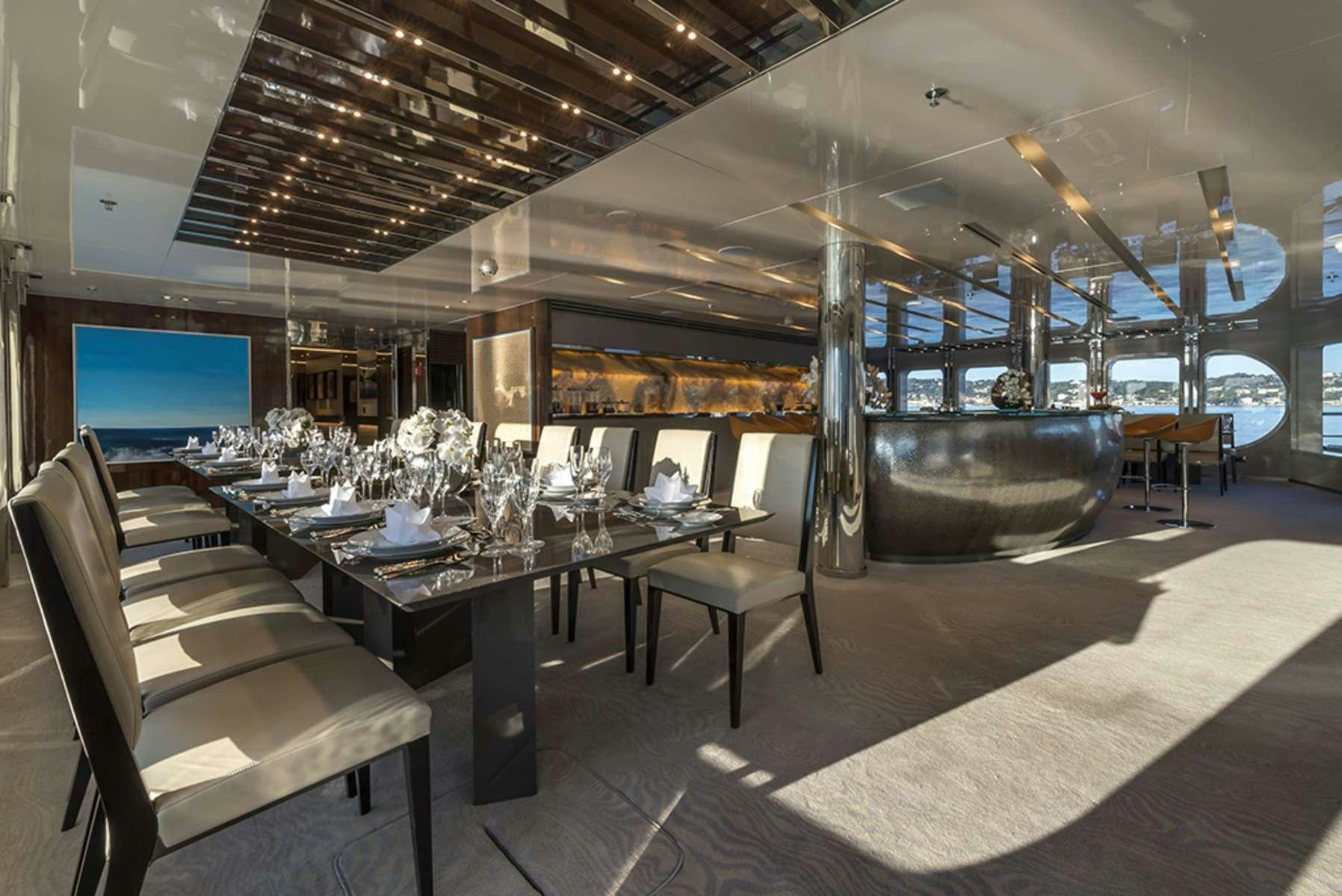 a room with a table and chairs aboard SERENITY Yacht for Charter