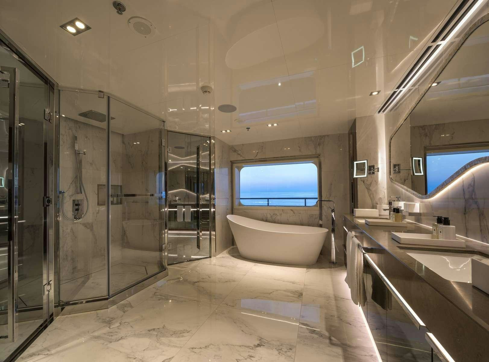 a bathroom with a large glass shower aboard SERENITY Yacht for Charter