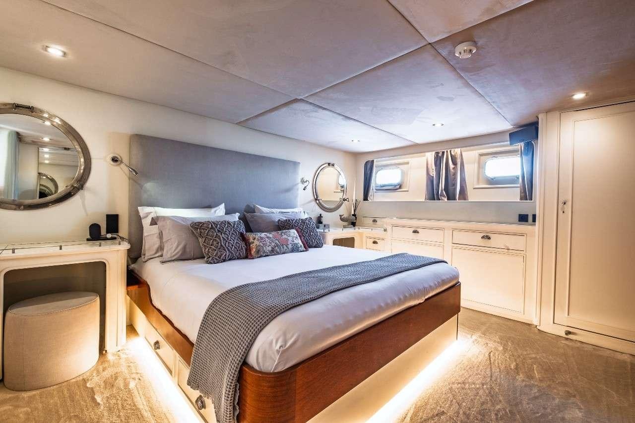 a bedroom with a bed and a mirror aboard STALCA Yacht for Charter