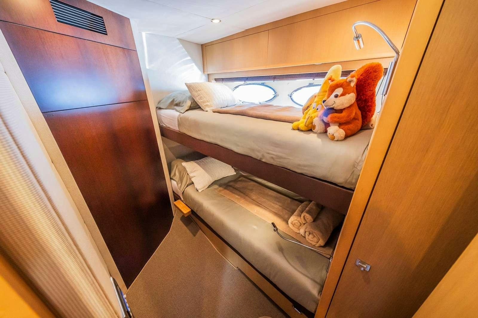 a room with a bed and a desk aboard GITANA II Yacht for Charter