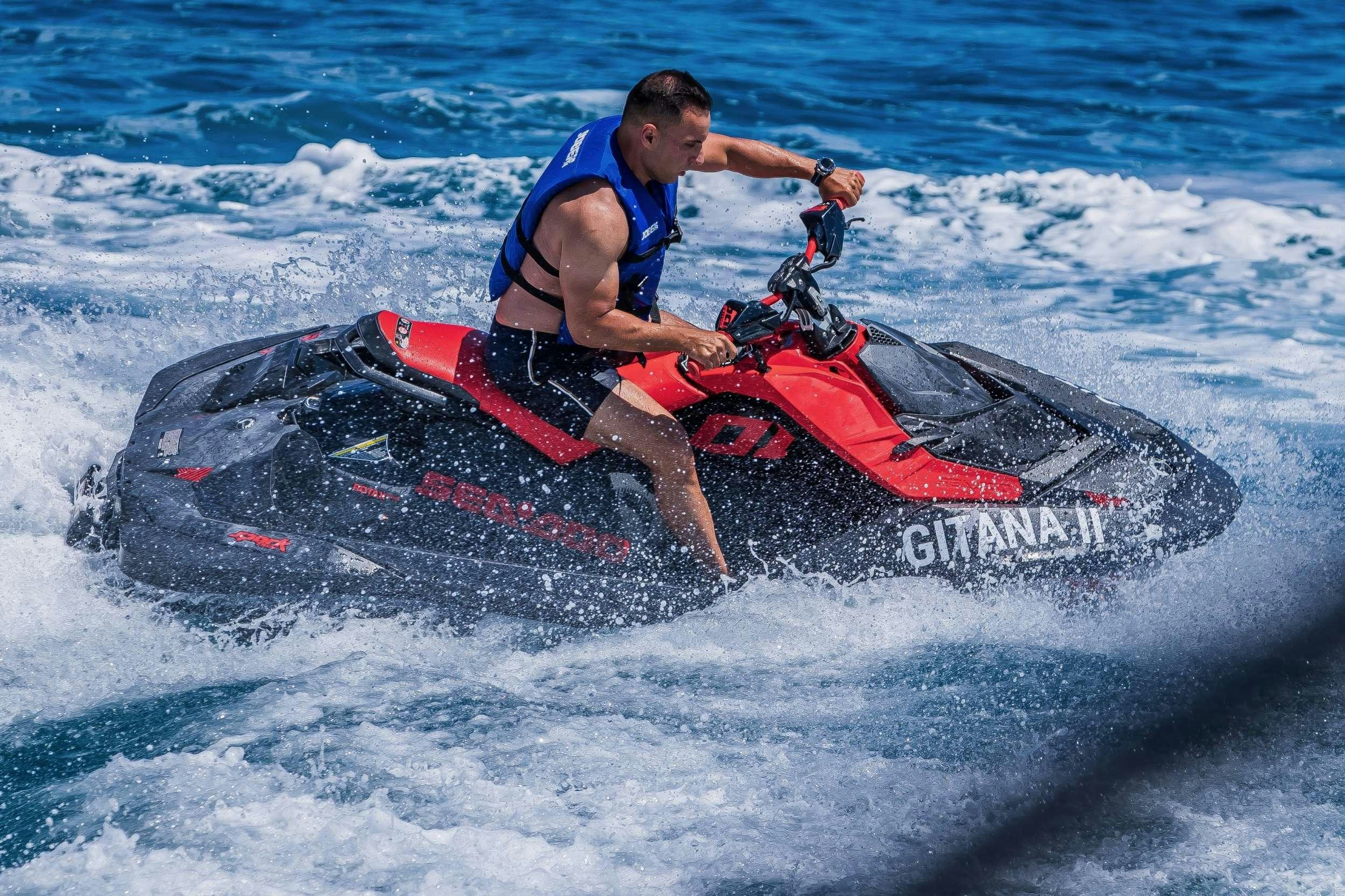 a man riding a jet ski aboard GITANA II Yacht for Charter