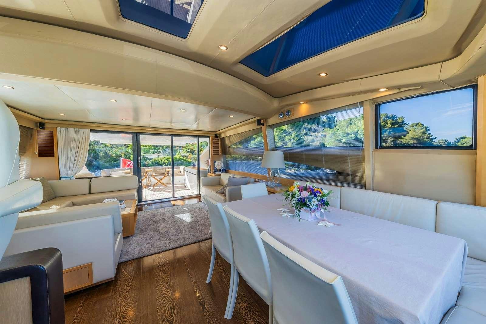 a large living room with a large table and chairs aboard GITANA II Yacht for Charter