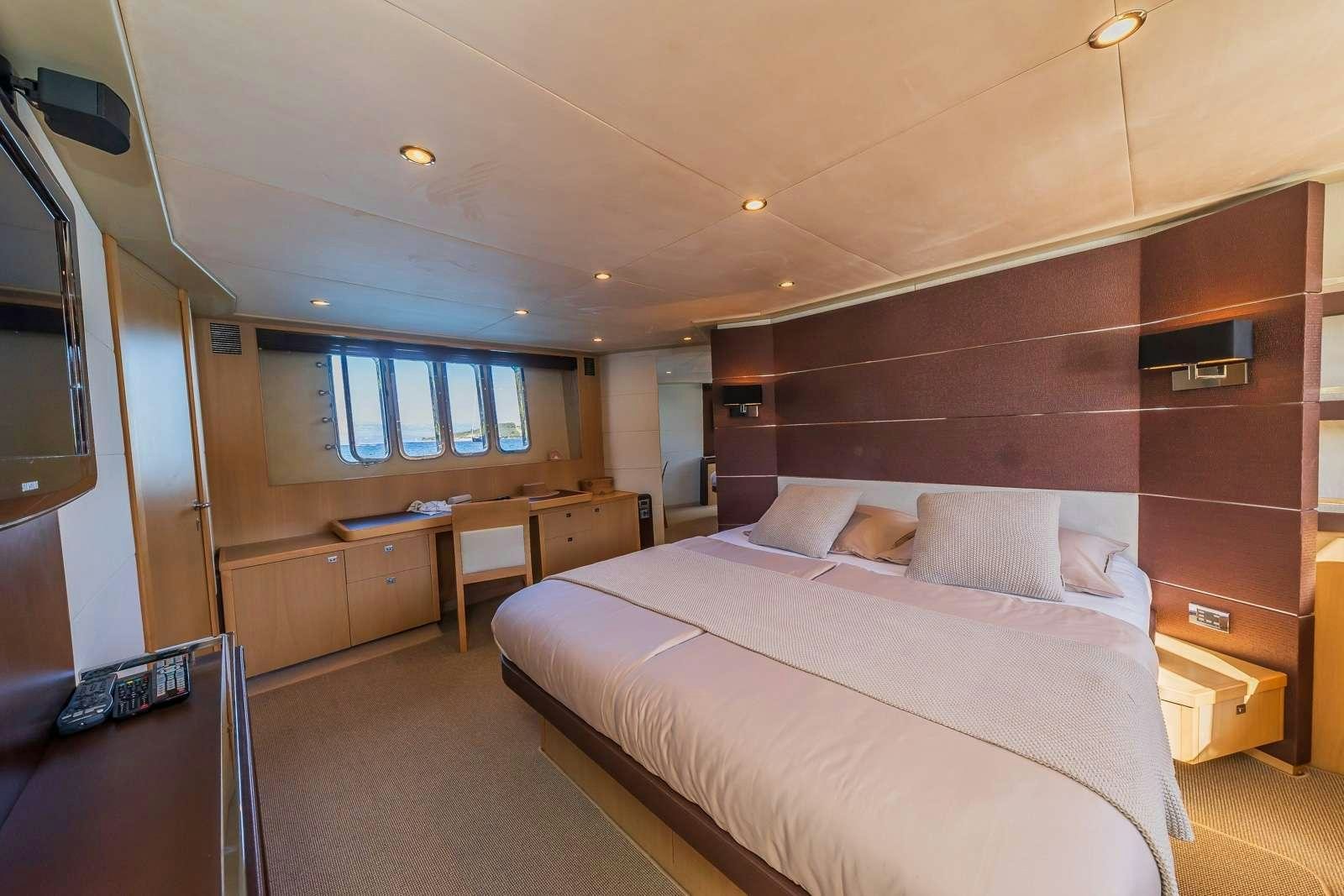 a room with a bed and a desk aboard GITANA II Yacht for Charter