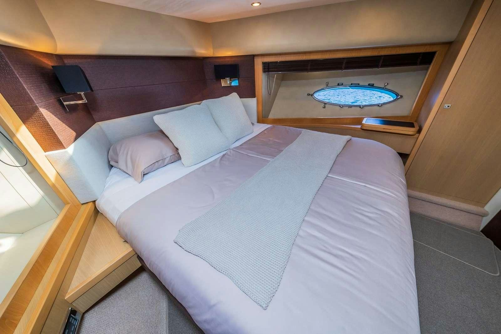 a bed with a white sheet aboard GITANA II Yacht for Charter