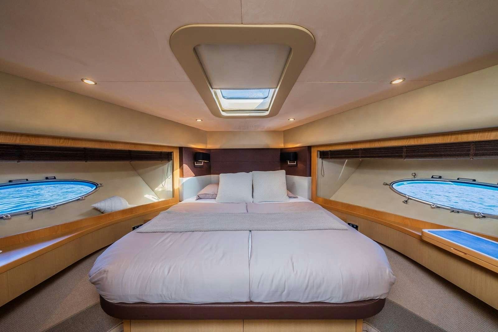a room with a bed and a pool table aboard GITANA II Yacht for Charter