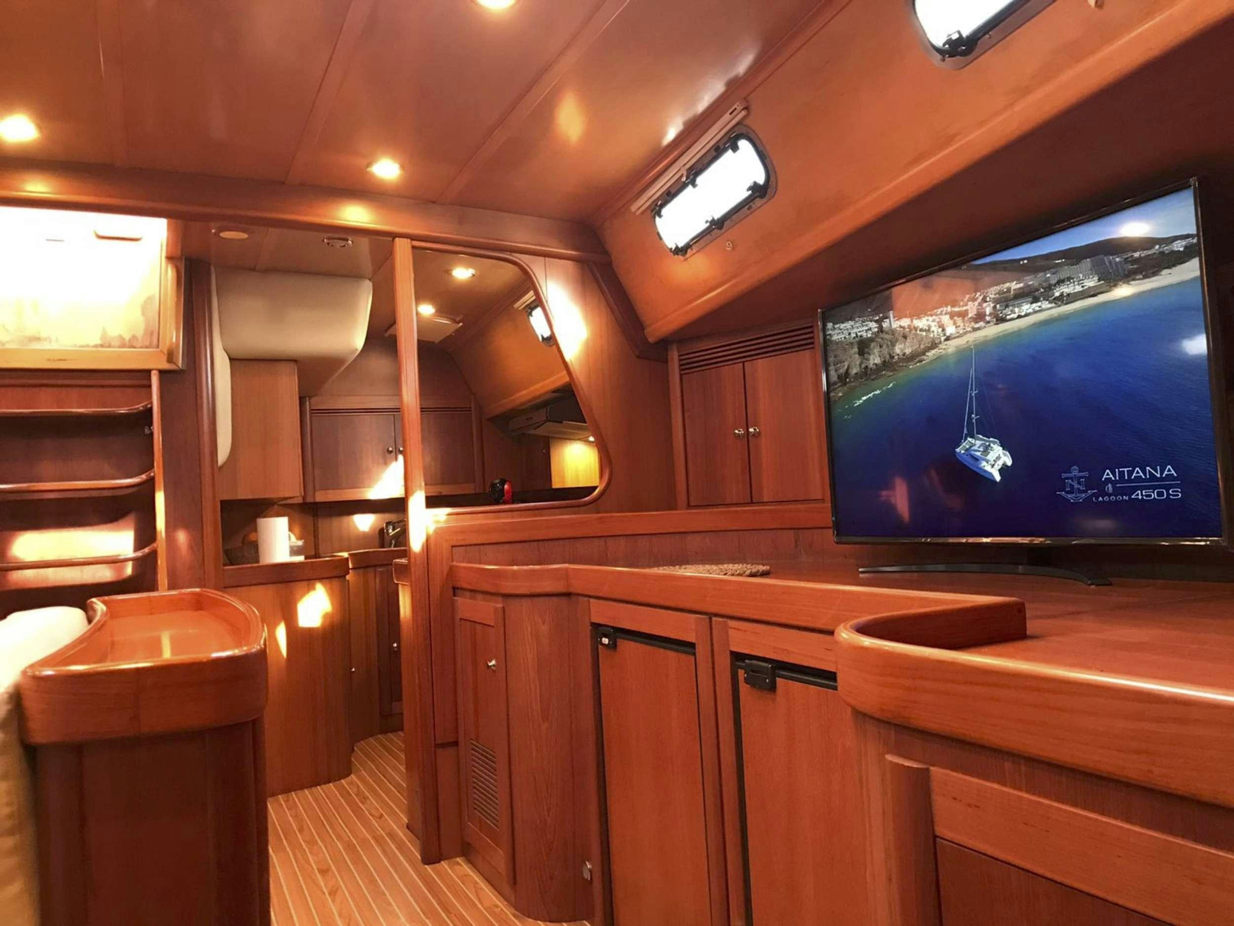 a room with wooden cabinets and a tv on the wall aboard COSTA NORD Yacht for Charter