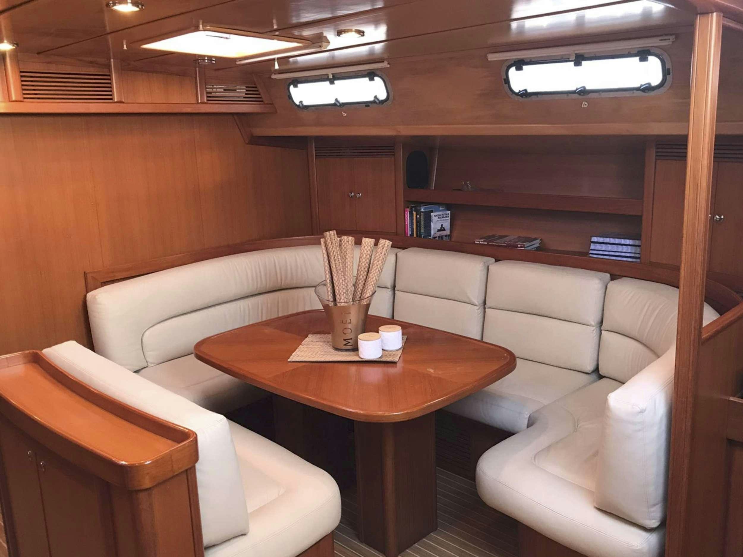 a room with a table and chairs aboard COSTA NORD Yacht for Charter