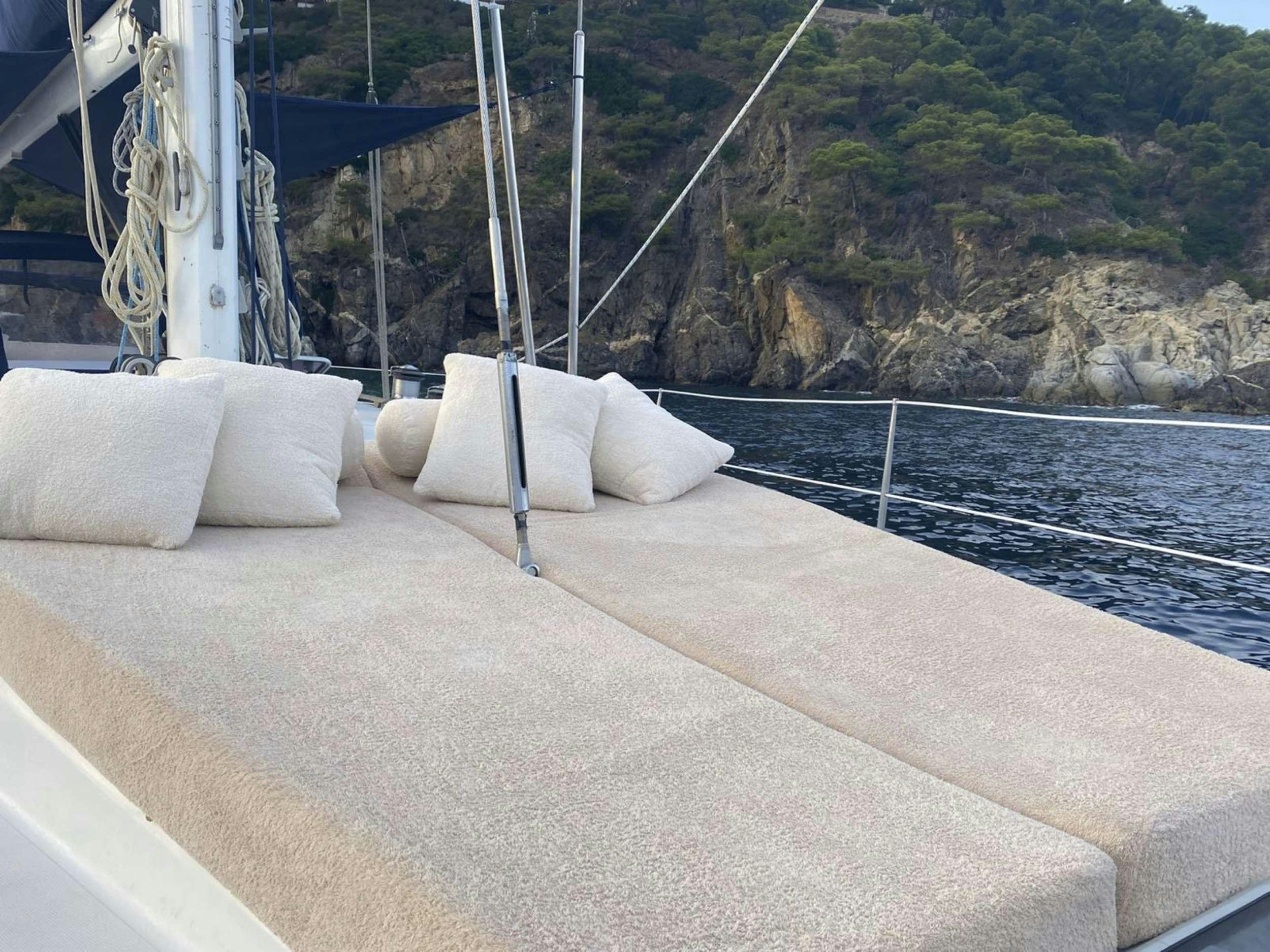 a deck with pillows on it aboard COSTA NORD Yacht for Charter