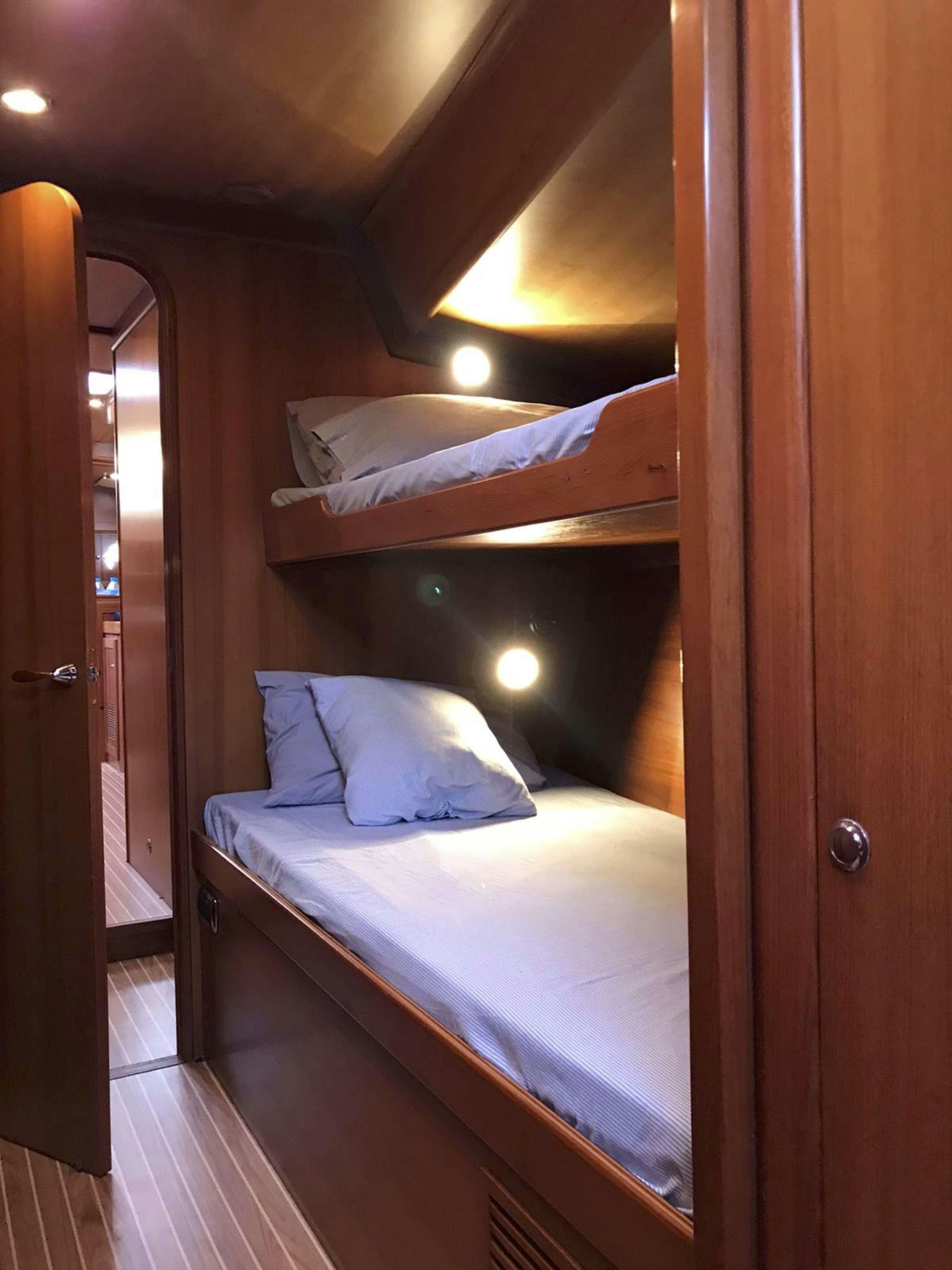 a bed with a white sheet aboard COSTA NORD Yacht for Charter