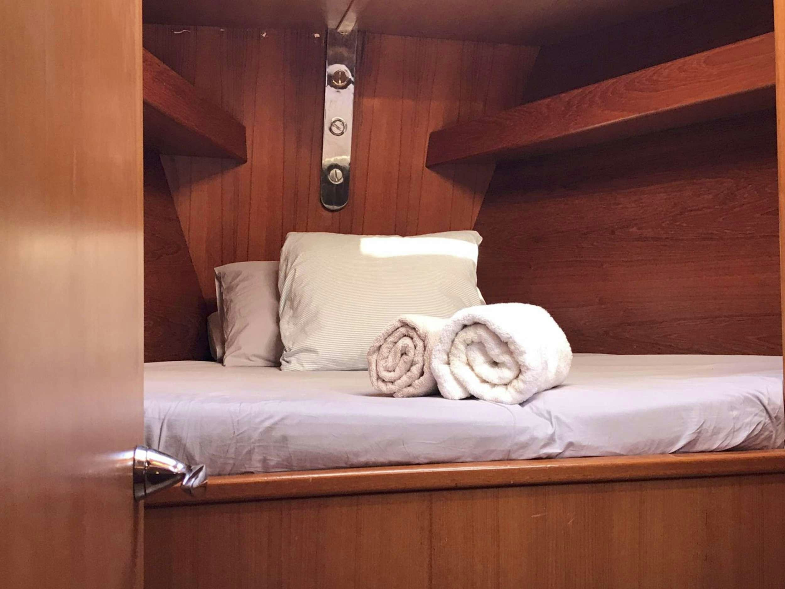 a cat lying on a bed aboard COSTA NORD Yacht for Charter