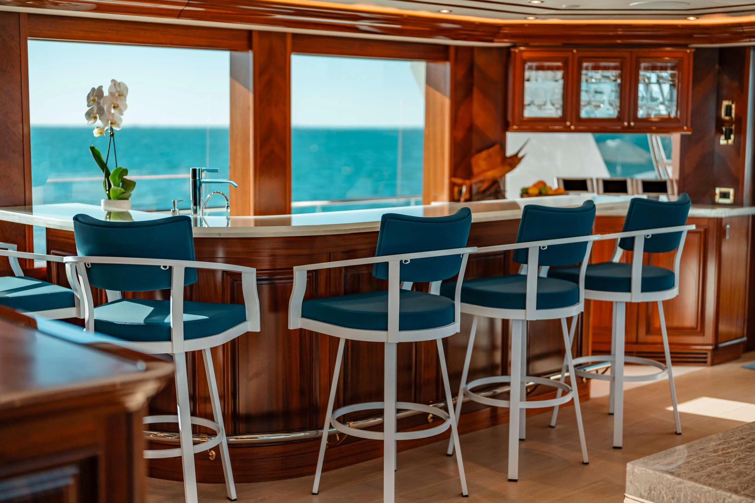a room with tables and chairs aboard BLUE TIME Yacht for Charter