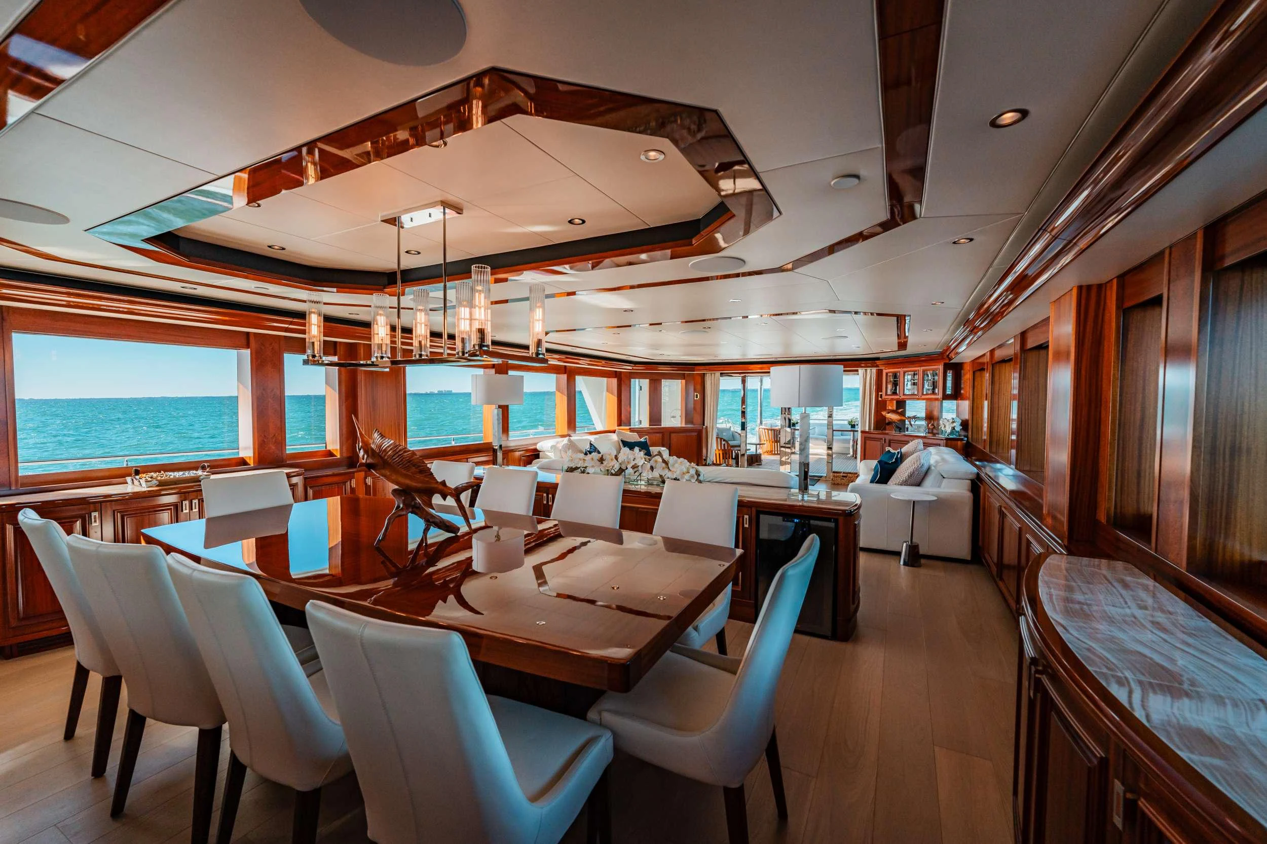 a room with tables and chairs aboard BLUE TIME Yacht for Charter