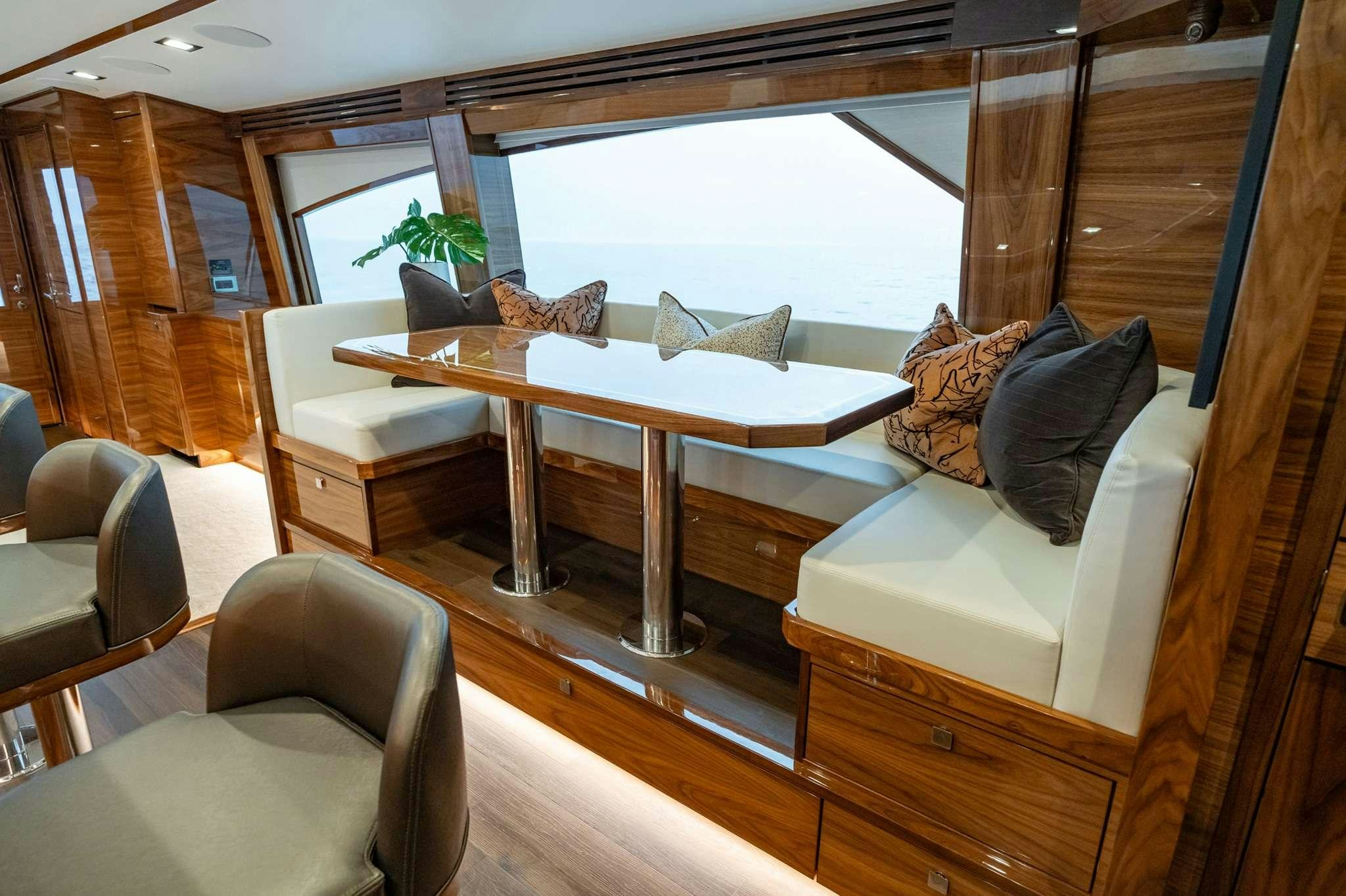 a room with a couch and a table and chairs aboard BOUJIE Yacht for Charter