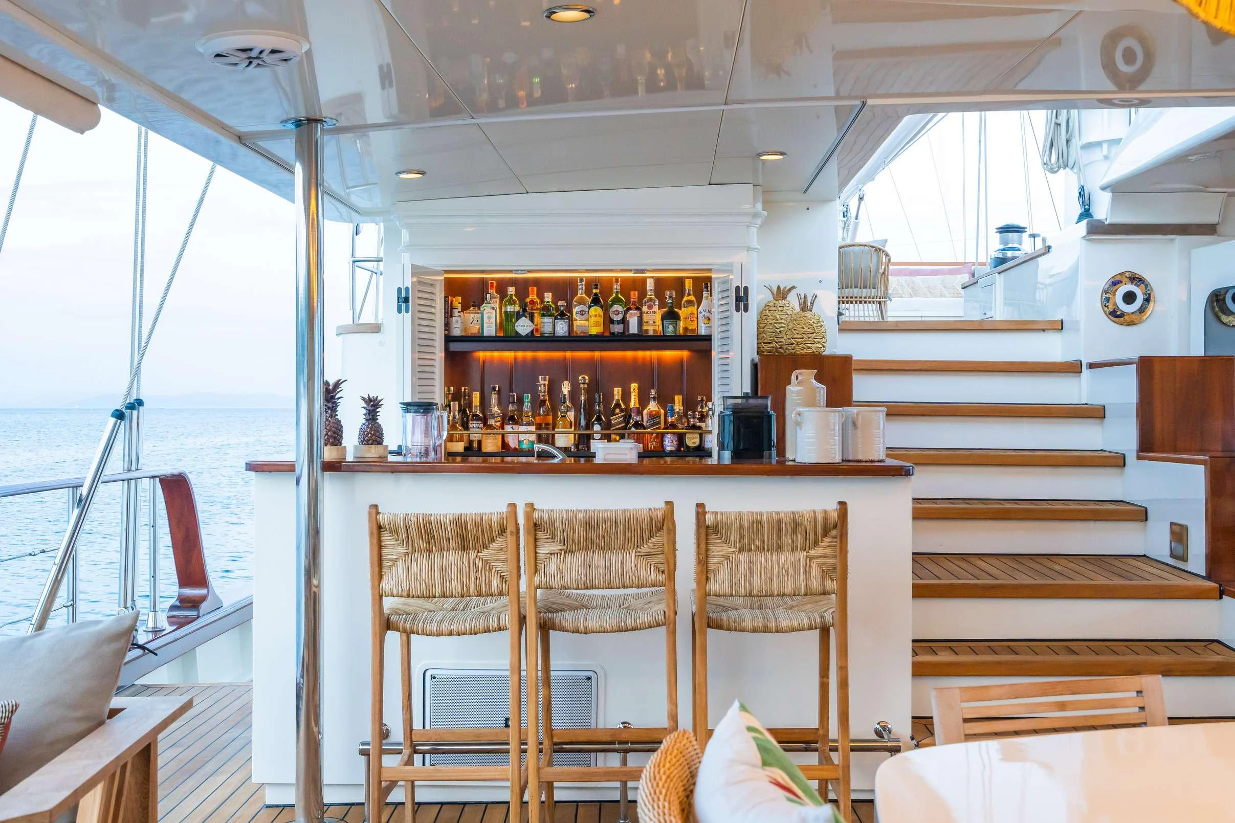 a bar with a table and chairs aboard YAZZ Yacht for Charter