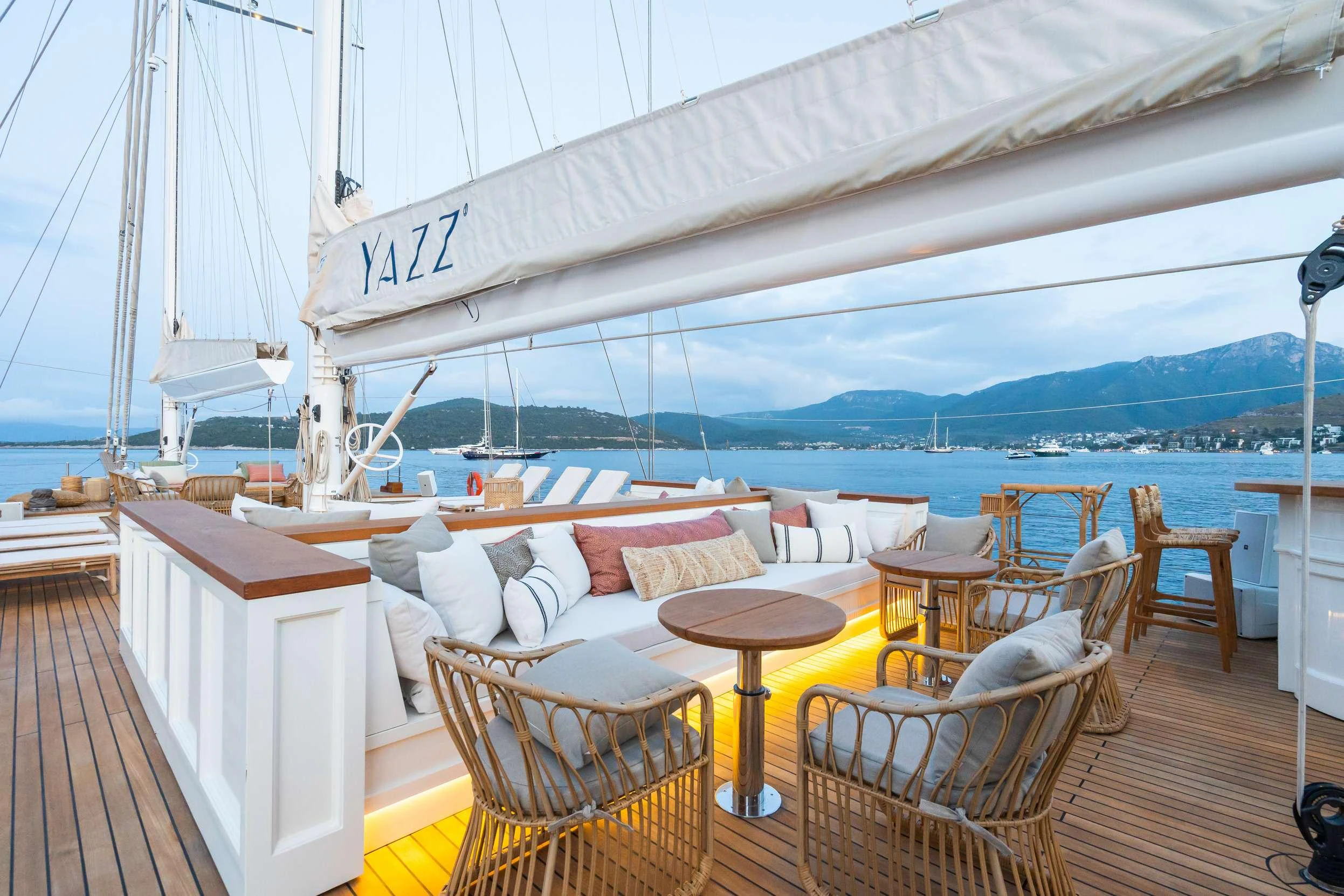 a deck with chairs and tables on it aboard YAZZ Yacht for Charter