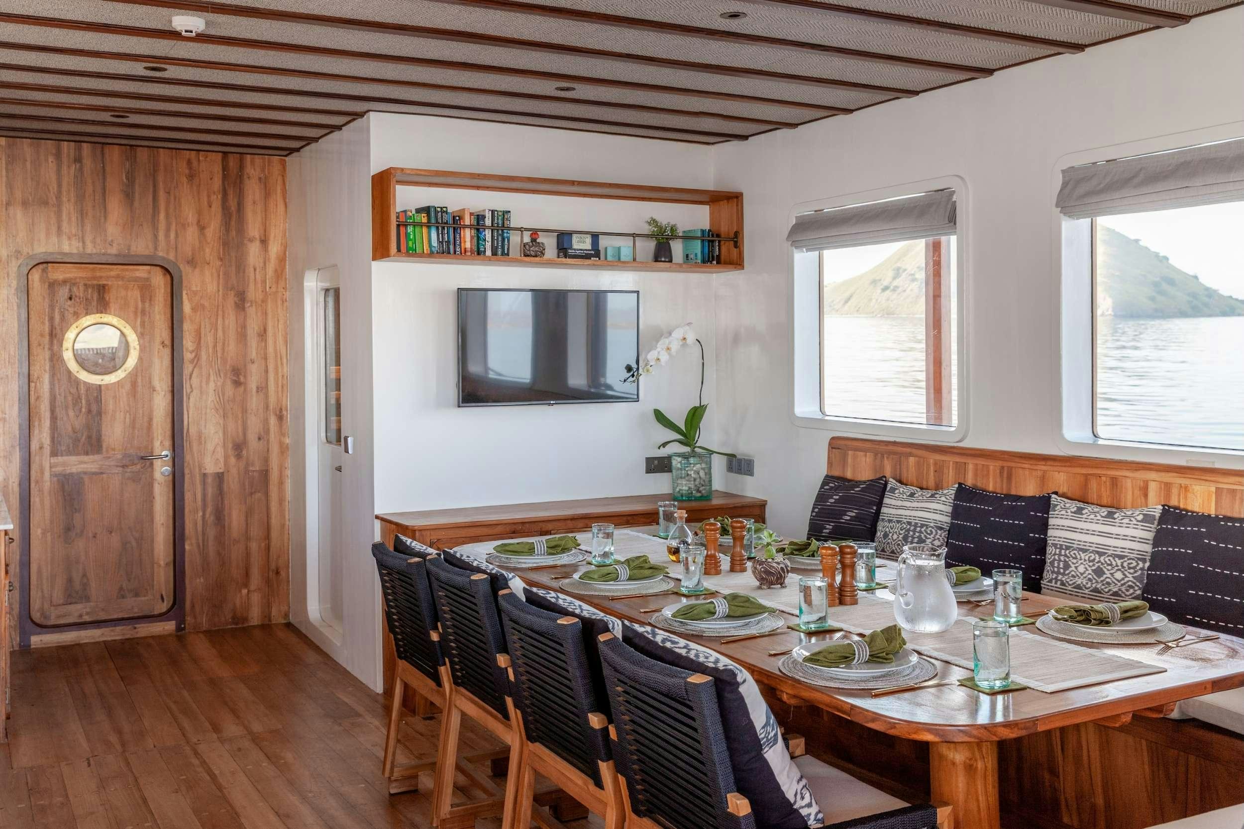a dining table in a room aboard REBEL Yacht for Charter