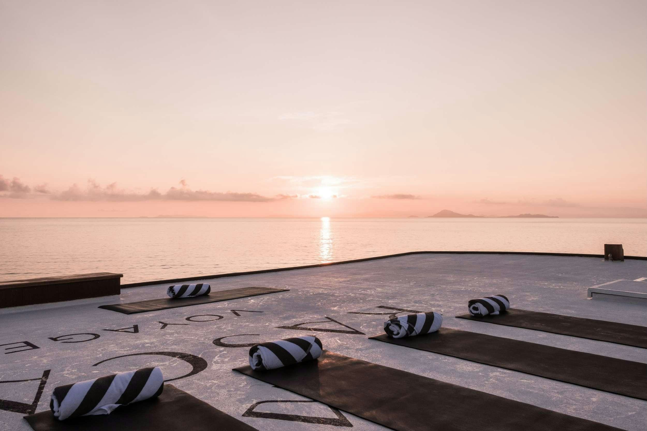 a sunset over a body of water aboard REBEL Yacht for Charter