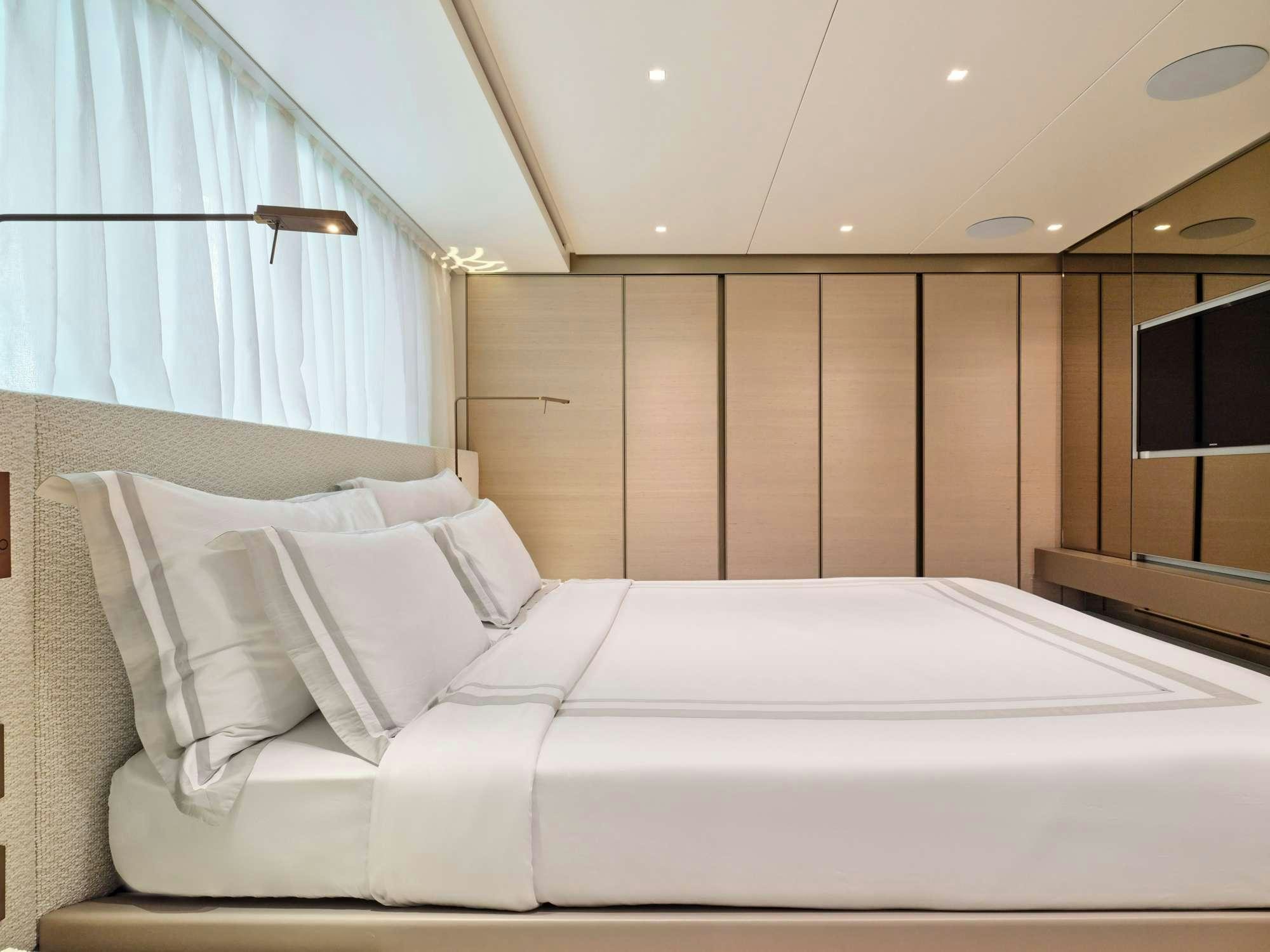 a bed with white sheets aboard MARY Yacht for Charter