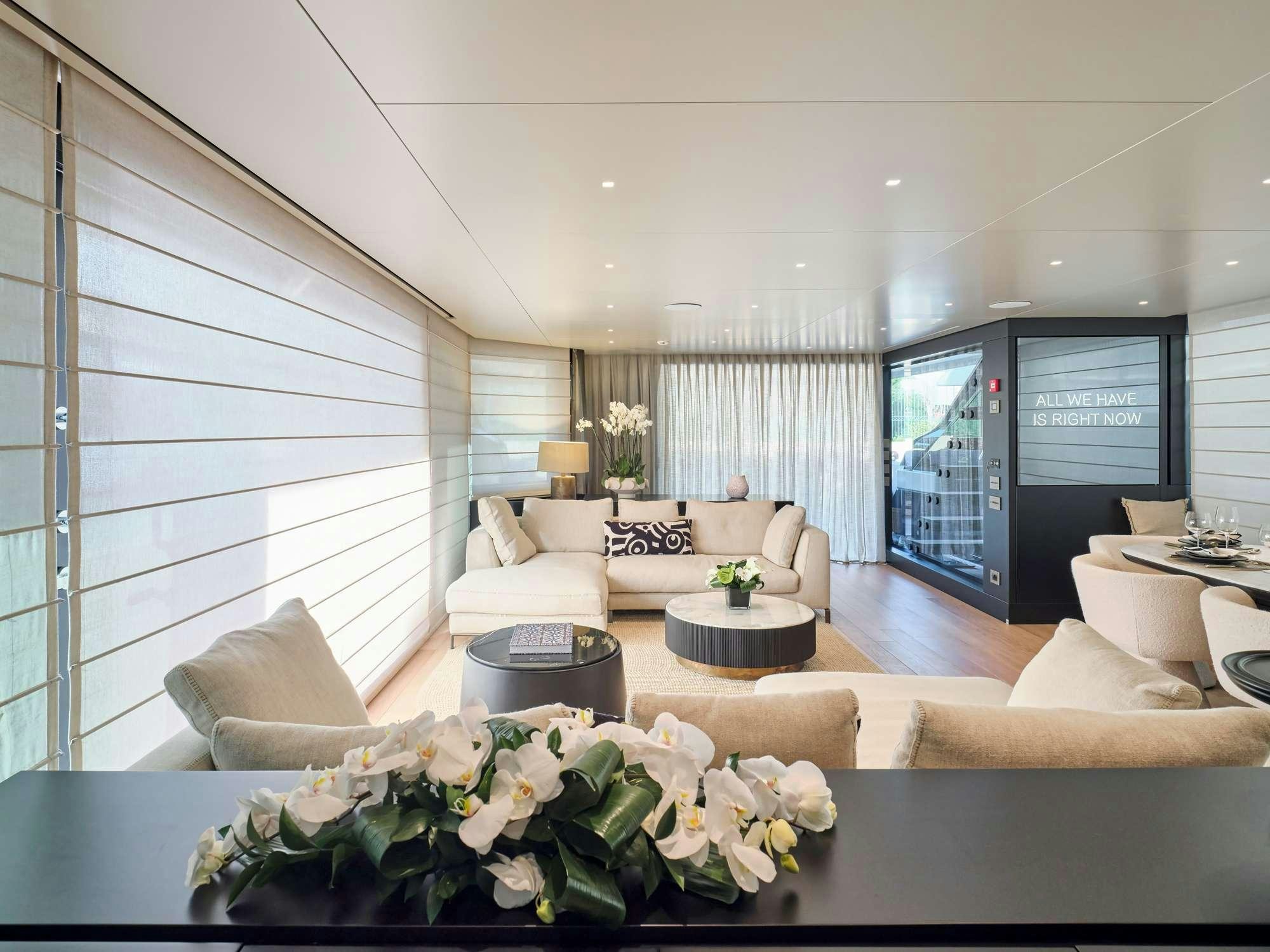 a living room with a large screen aboard MARY Yacht for Charter