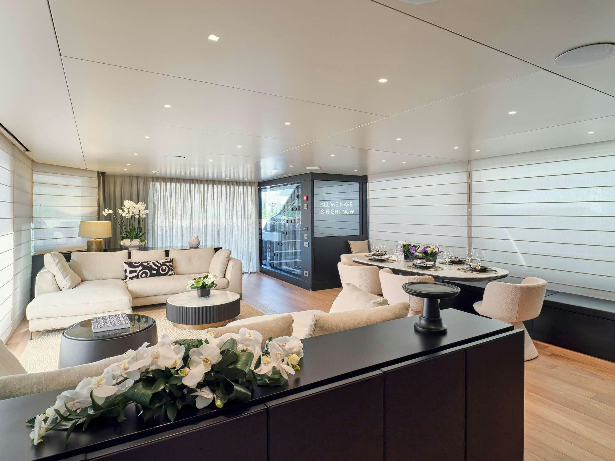 a living room with a large table aboard MARY Yacht for Charter