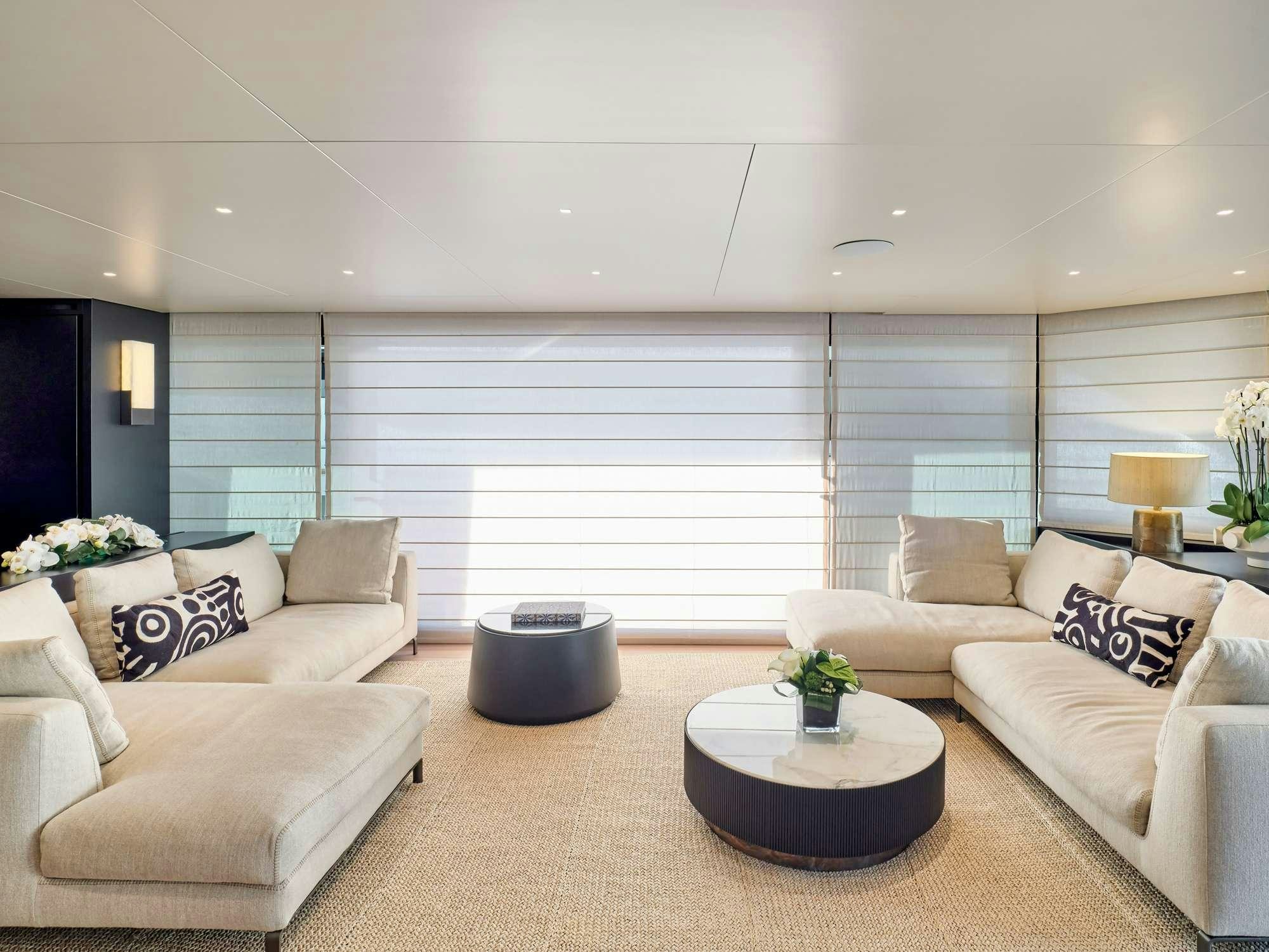 a living room with white furniture aboard MARY Yacht for Charter