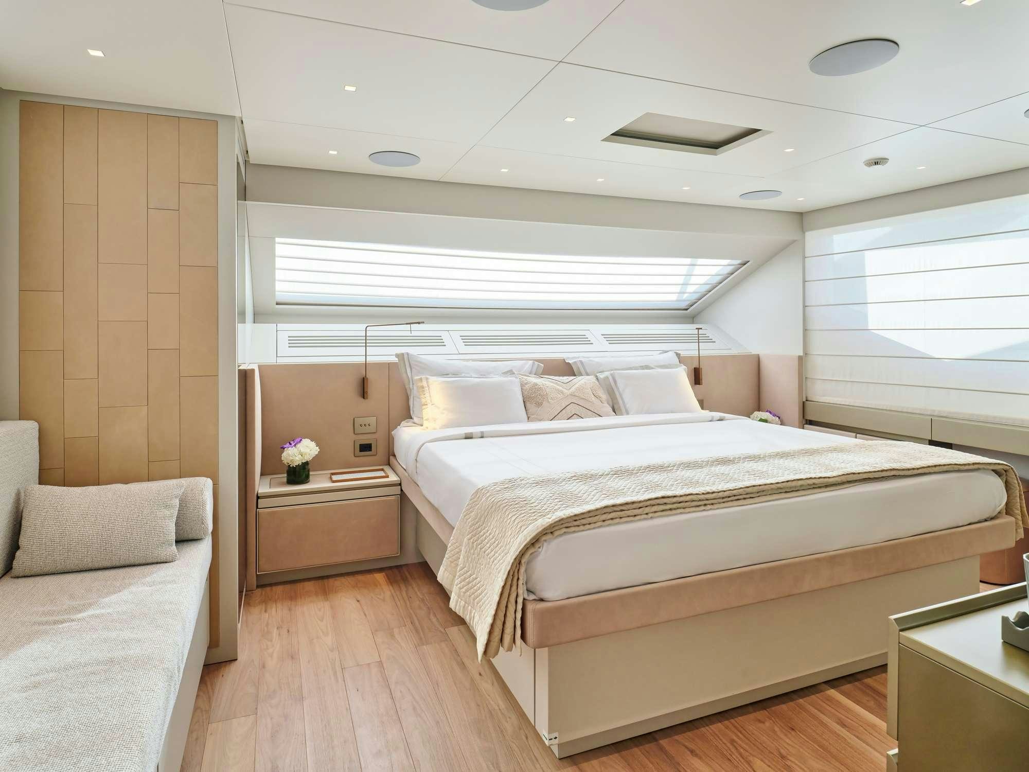 a room with a bed and a couch aboard MARY Yacht for Charter