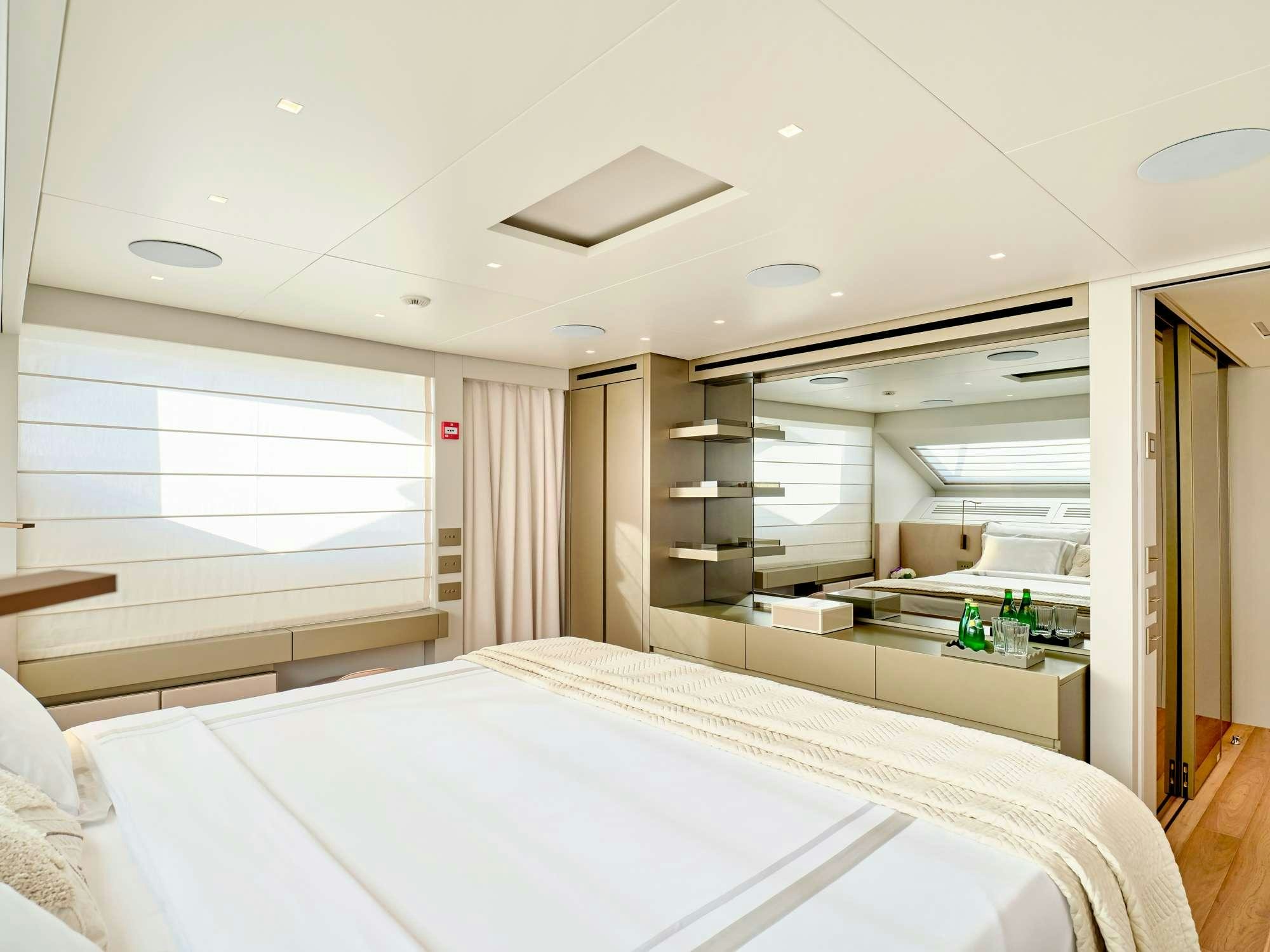 a room with a bed and a mirror aboard MARY Yacht for Charter
