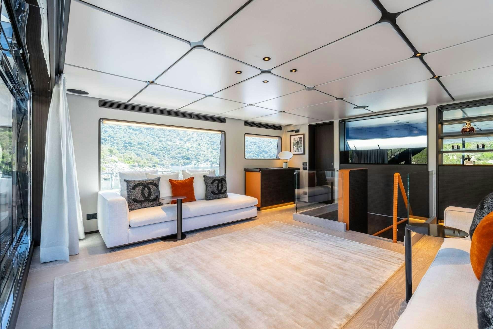 a room with a couch and a tv aboard AT ONE Yacht for Charter
