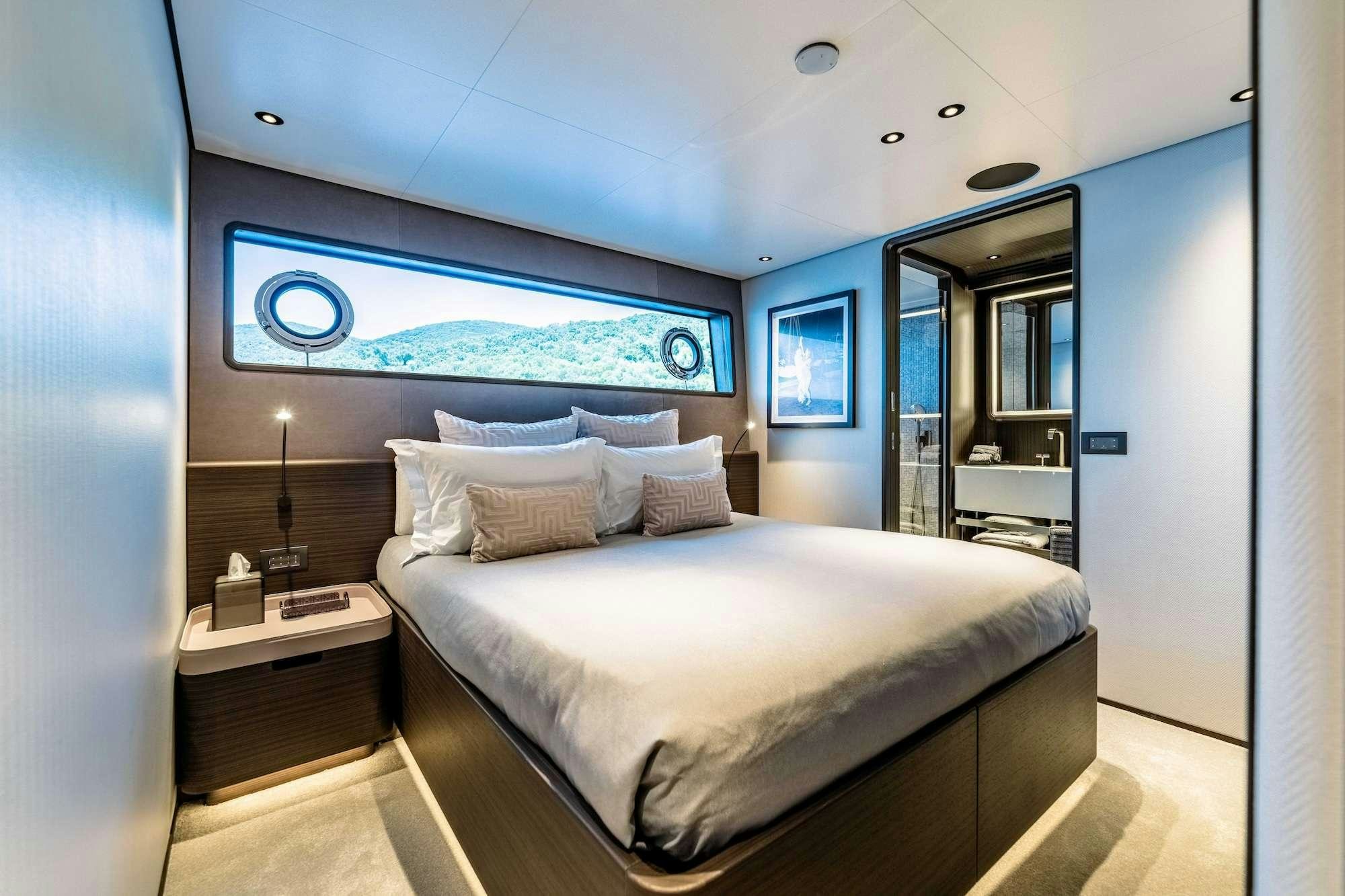 a bedroom with a bed and a desk aboard AT ONE Yacht for Charter