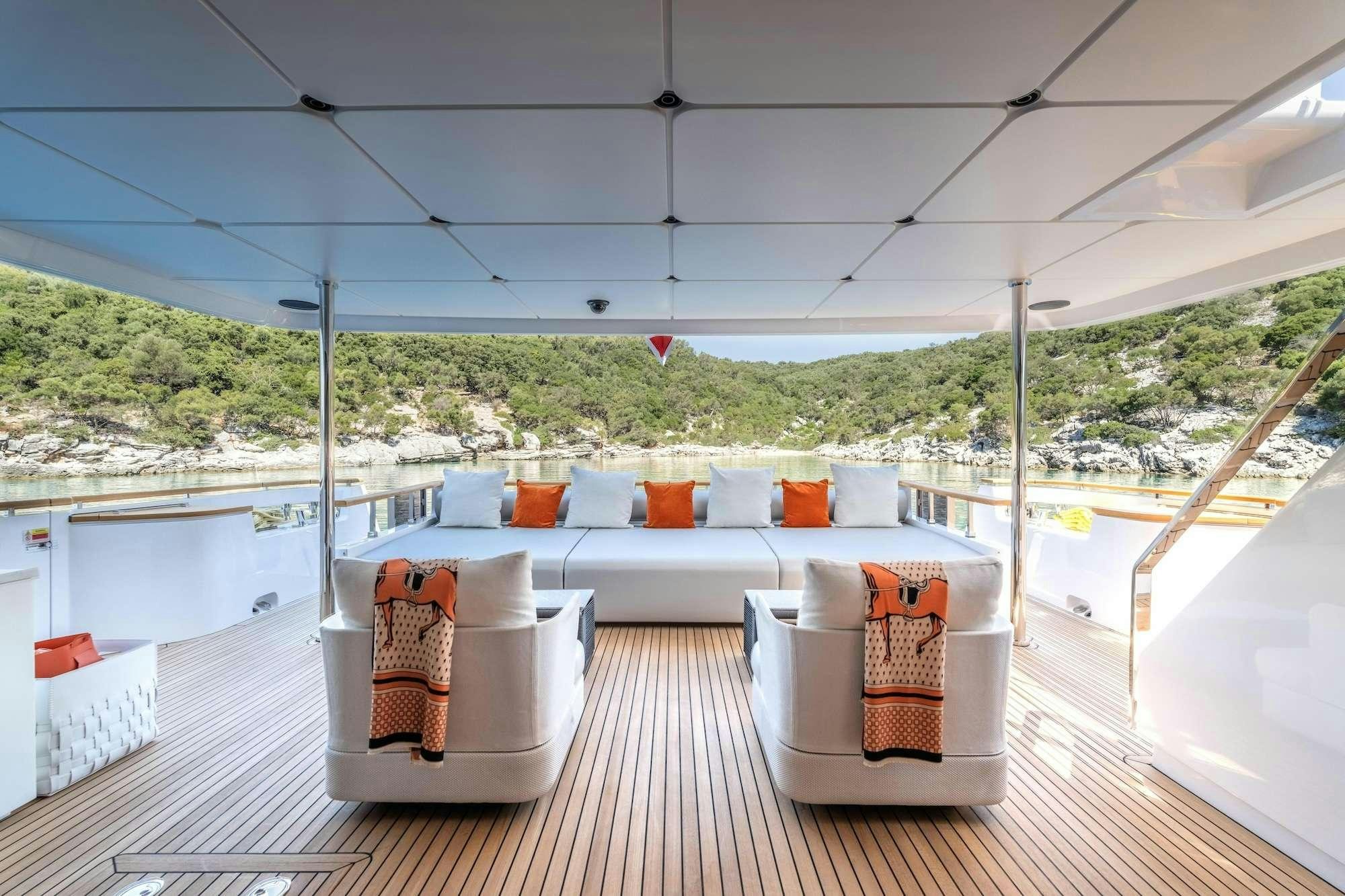 a patio with a table and chairs aboard AT ONE Yacht for Charter