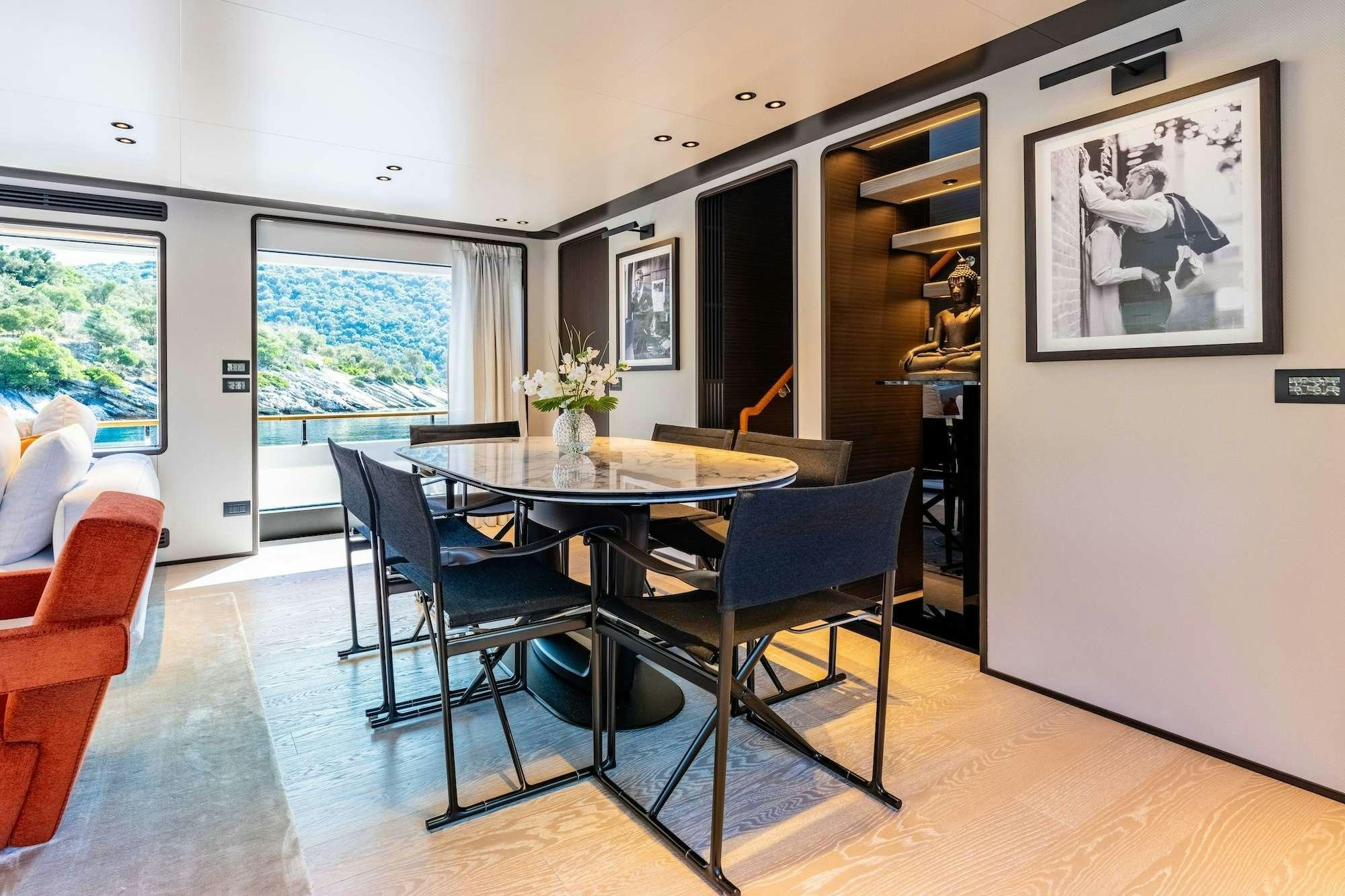 a dining room with a table and chairs aboard AT ONE Yacht for Charter