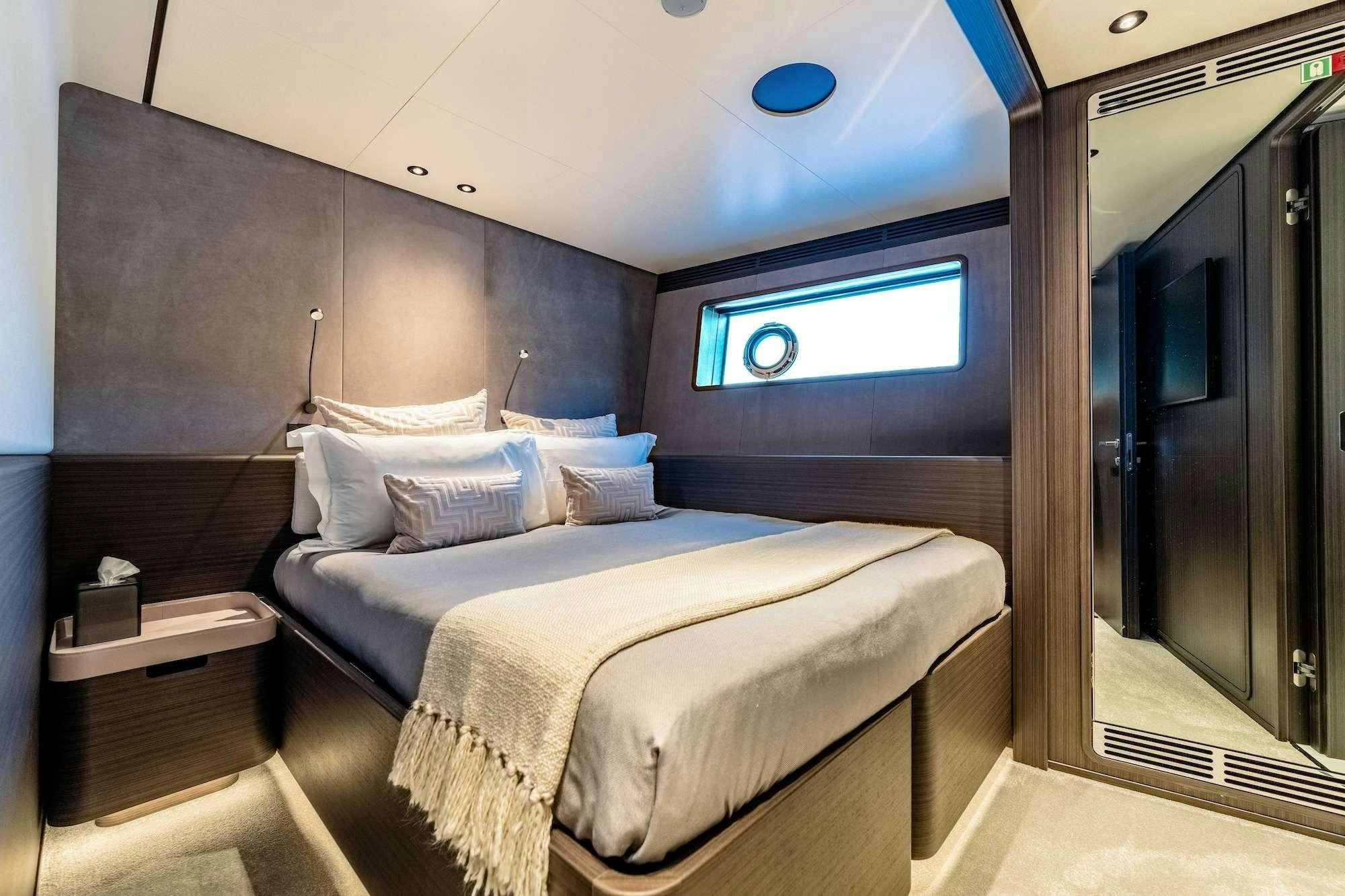 a bed in a room aboard AT ONE Yacht for Charter