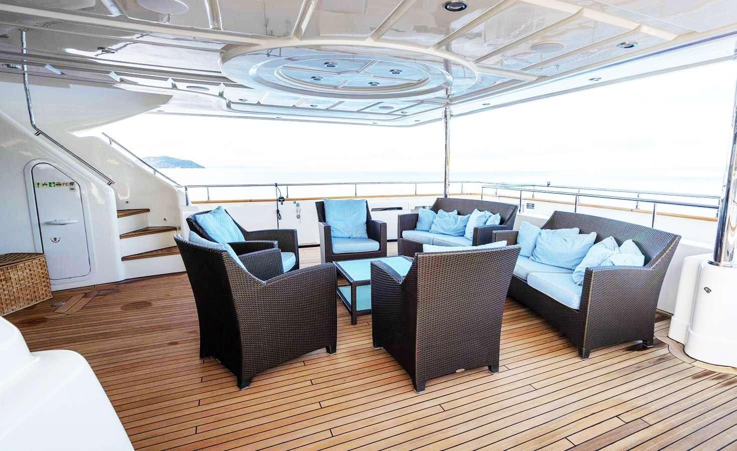 a room with a couch and a table and chairs aboard PARADISE Yacht for Charter