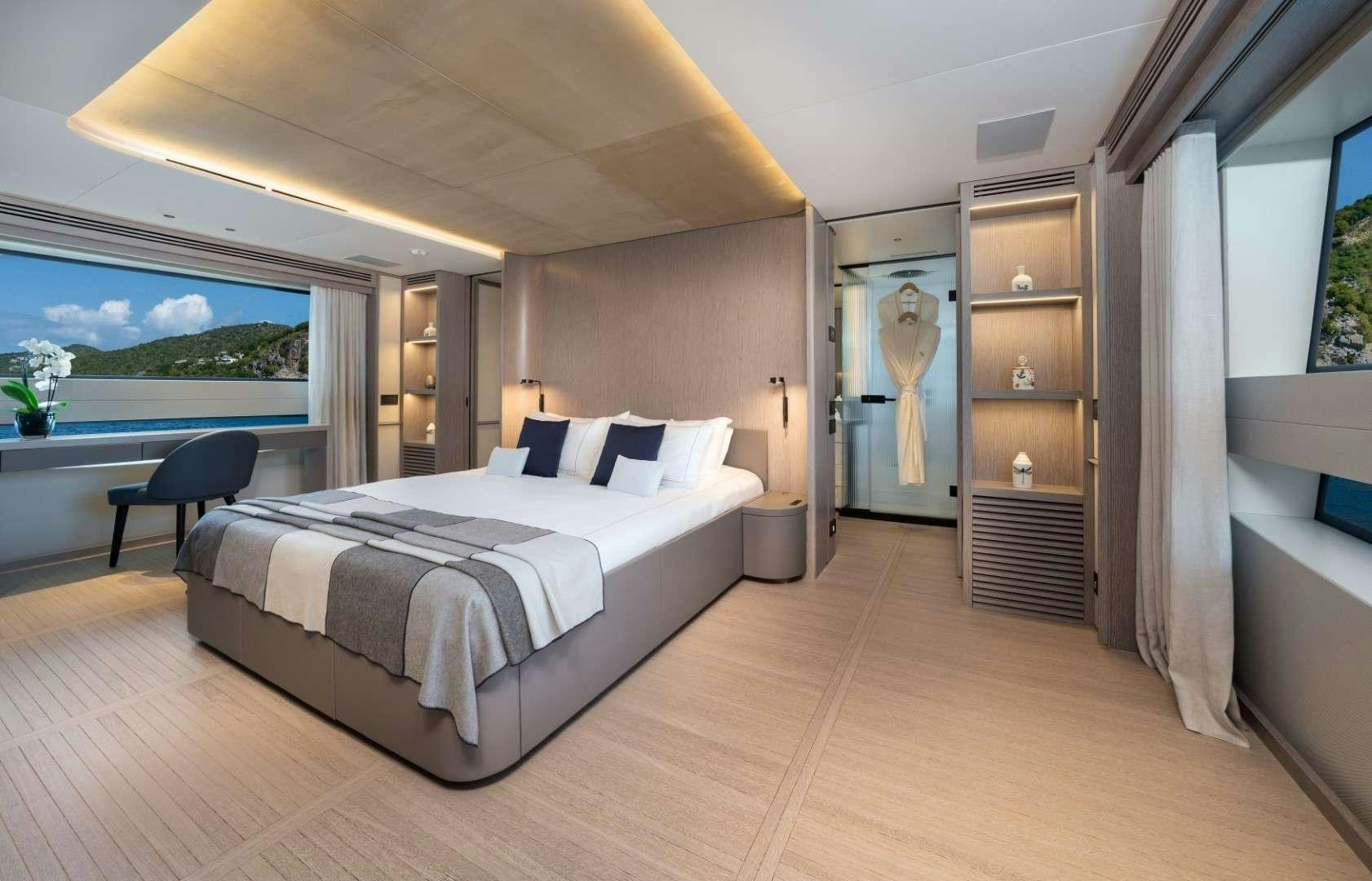 a large bedroom with a large bed aboard KINGS LAIR Yacht for Charter