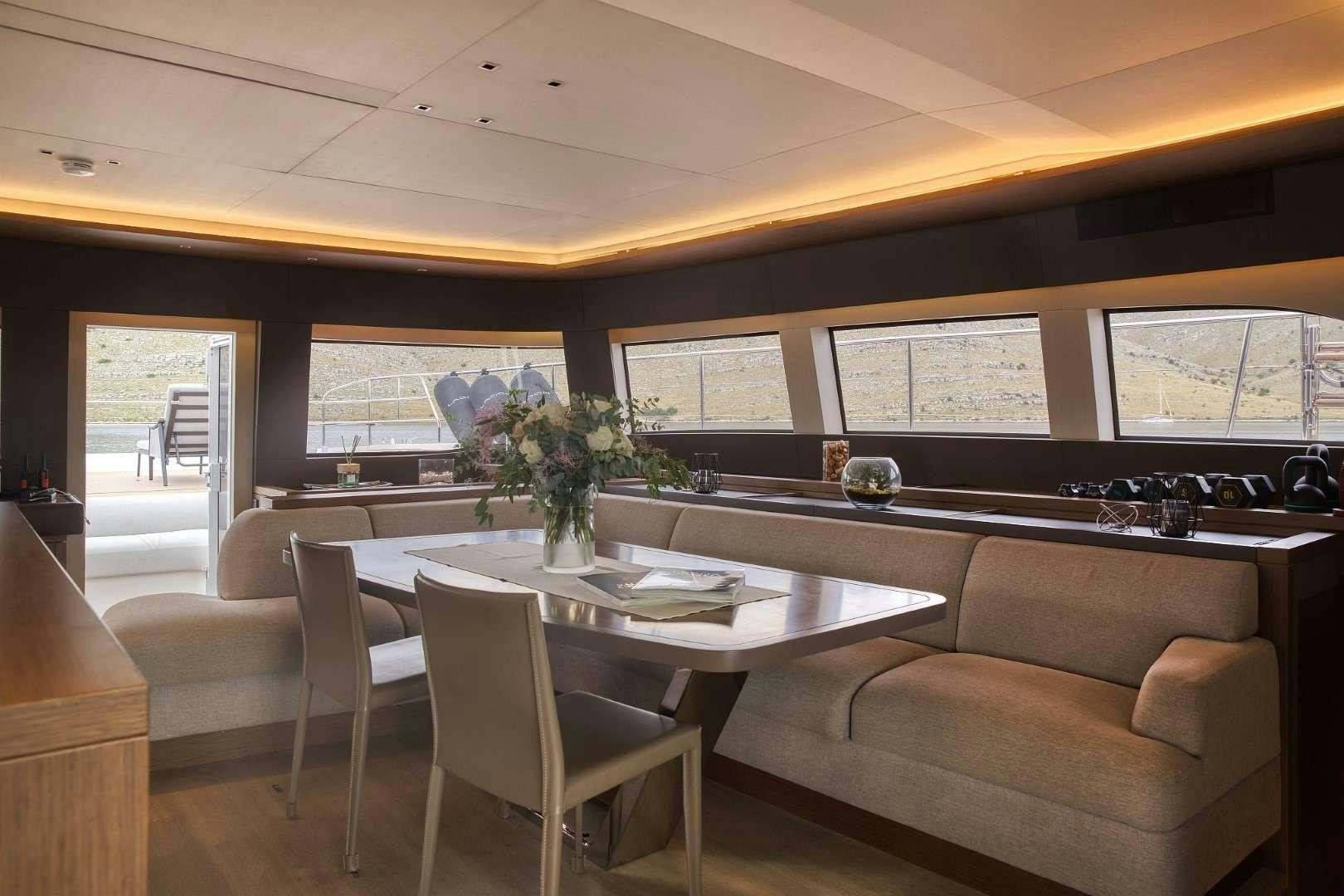 a room with a table and chairs aboard MASTERMIND Yacht for Charter