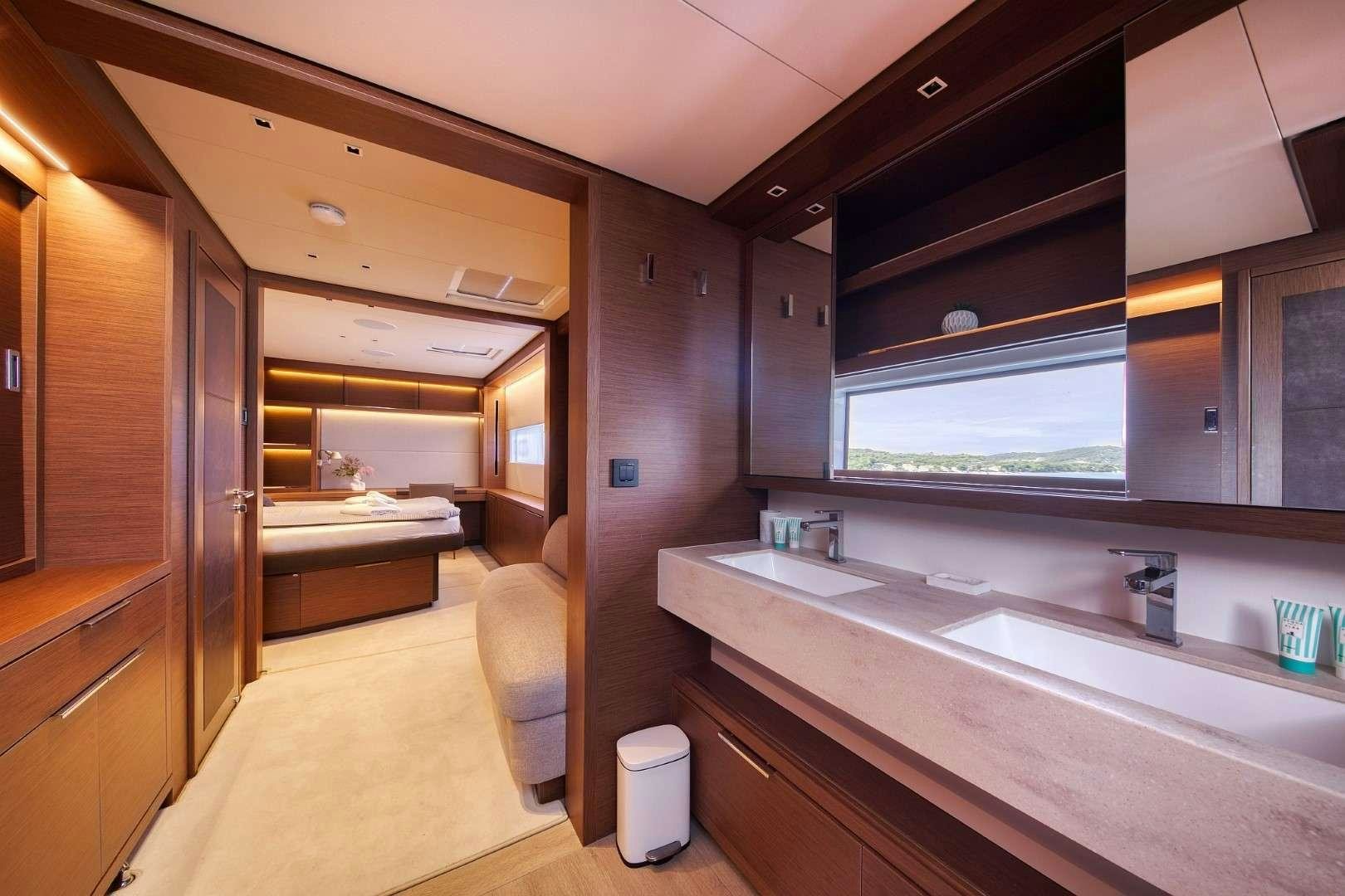 a bathroom with a tub sink and cabinets aboard MASTERMIND Yacht for Charter
