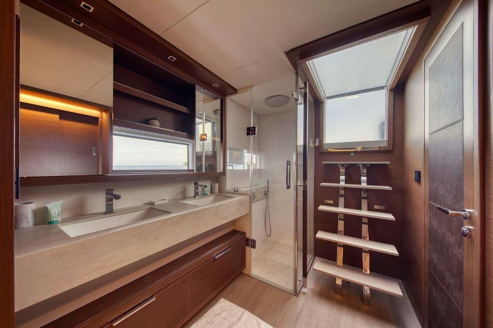 a bathroom with a sink and a mirror aboard MASTERMIND Yacht for Charter