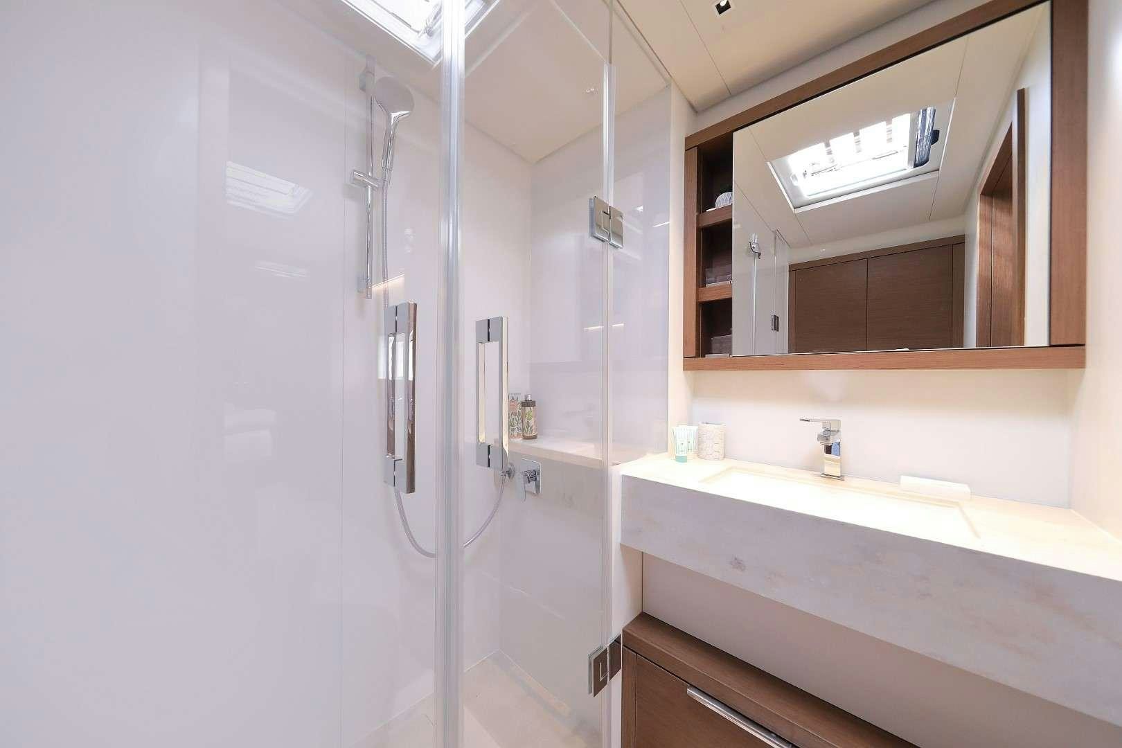 a bathroom with a sink and a mirror aboard MASTERMIND Yacht for Charter