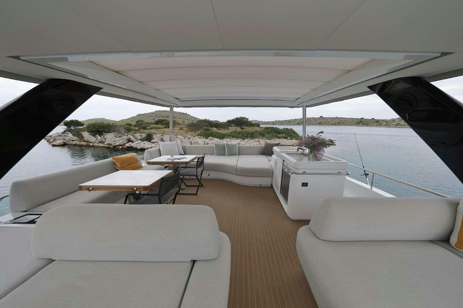 a room with a couch and chairs aboard MASTERMIND Yacht for Charter