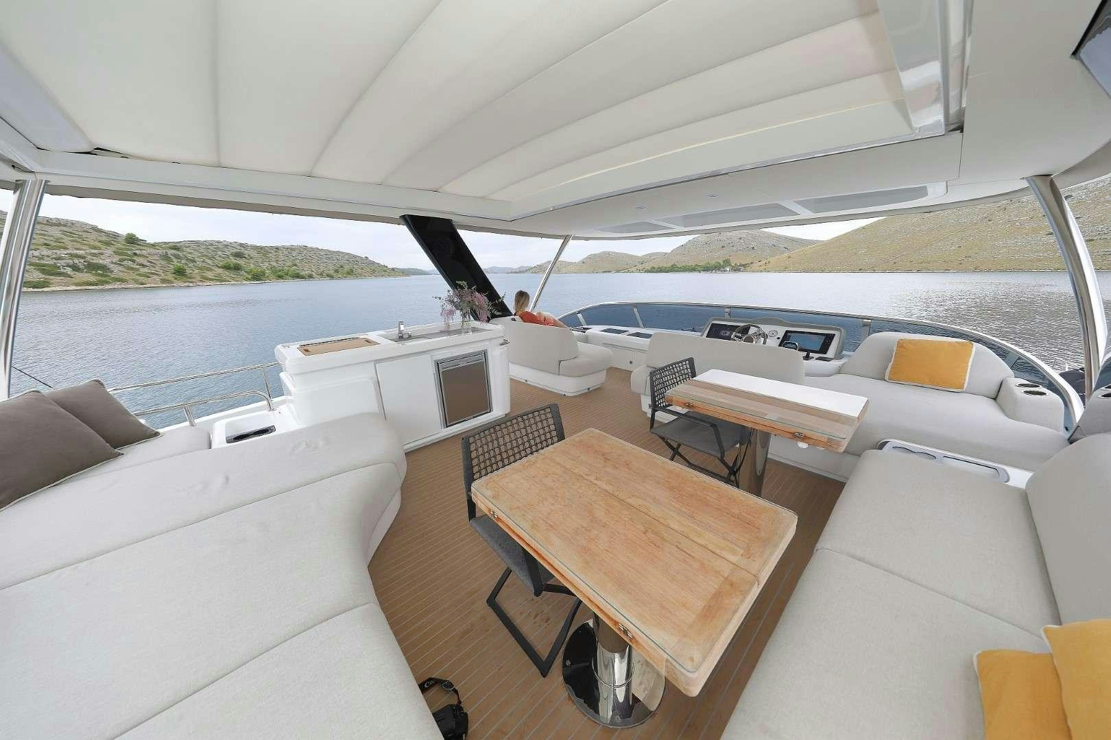 a boat with a table and chairs aboard MASTERMIND Yacht for Charter