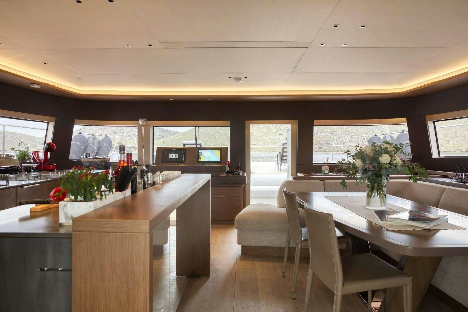 a kitchen with a table and chairs aboard MASTERMIND Yacht for Charter