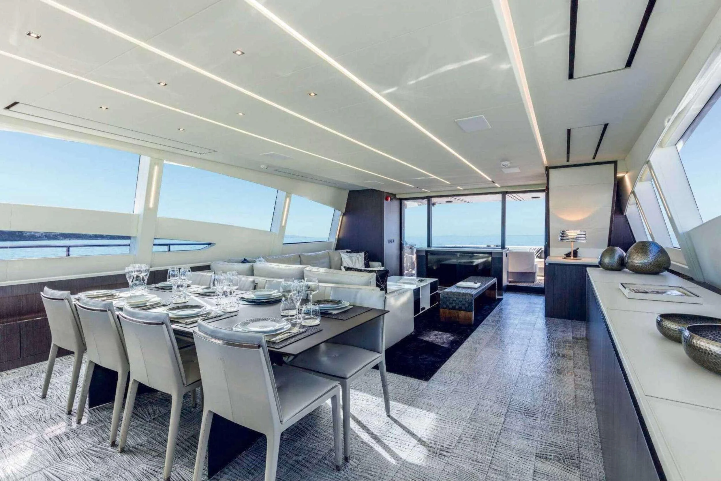 a large dining room with a large table and chairs aboard NAAV Yacht for Charter