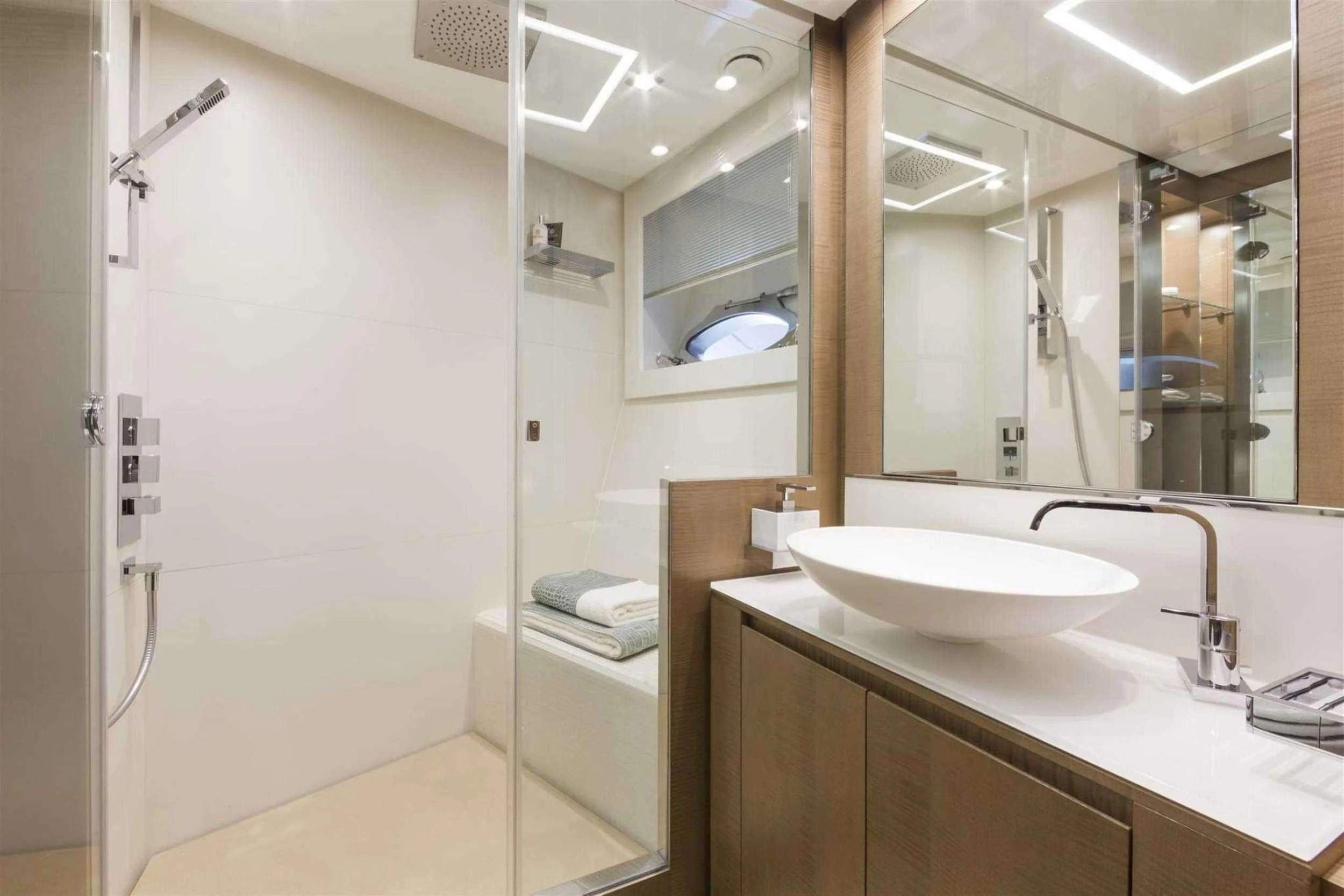 a bathroom with a sink and a mirror aboard NAAV Yacht for Charter