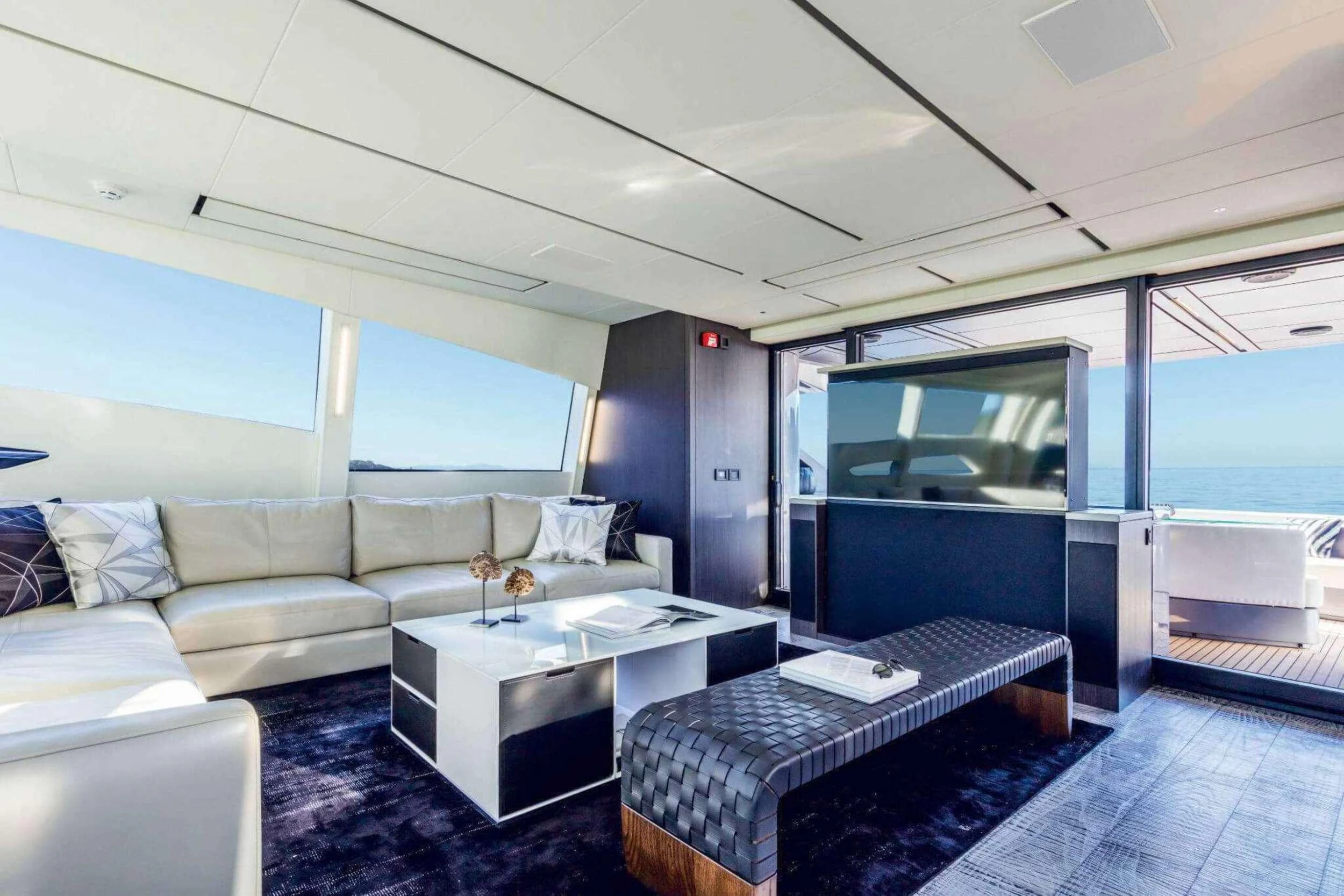 a room with a bed and a couch aboard NAAV Yacht for Charter