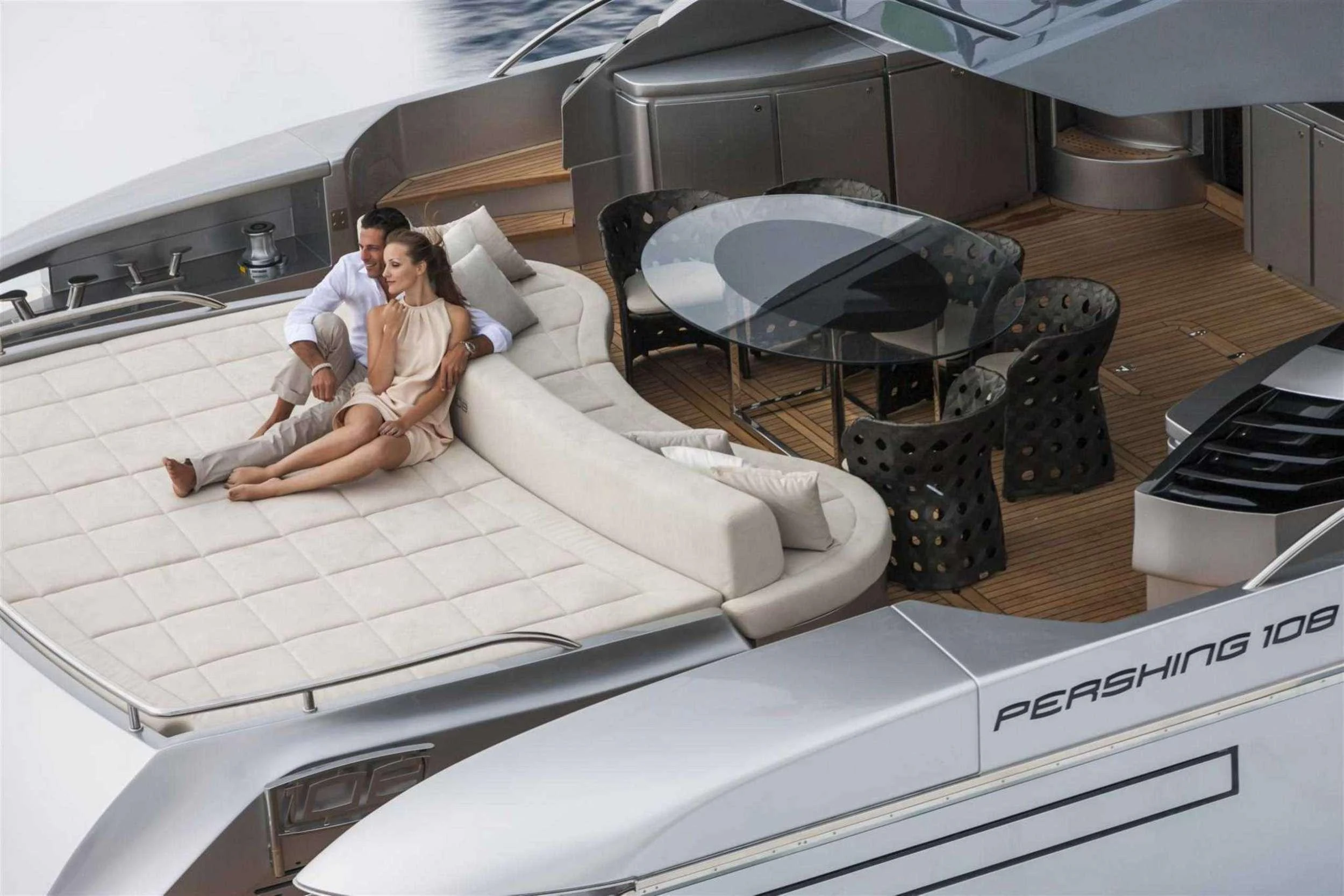 a man and woman sitting on a couch aboard NAAV Yacht for Charter