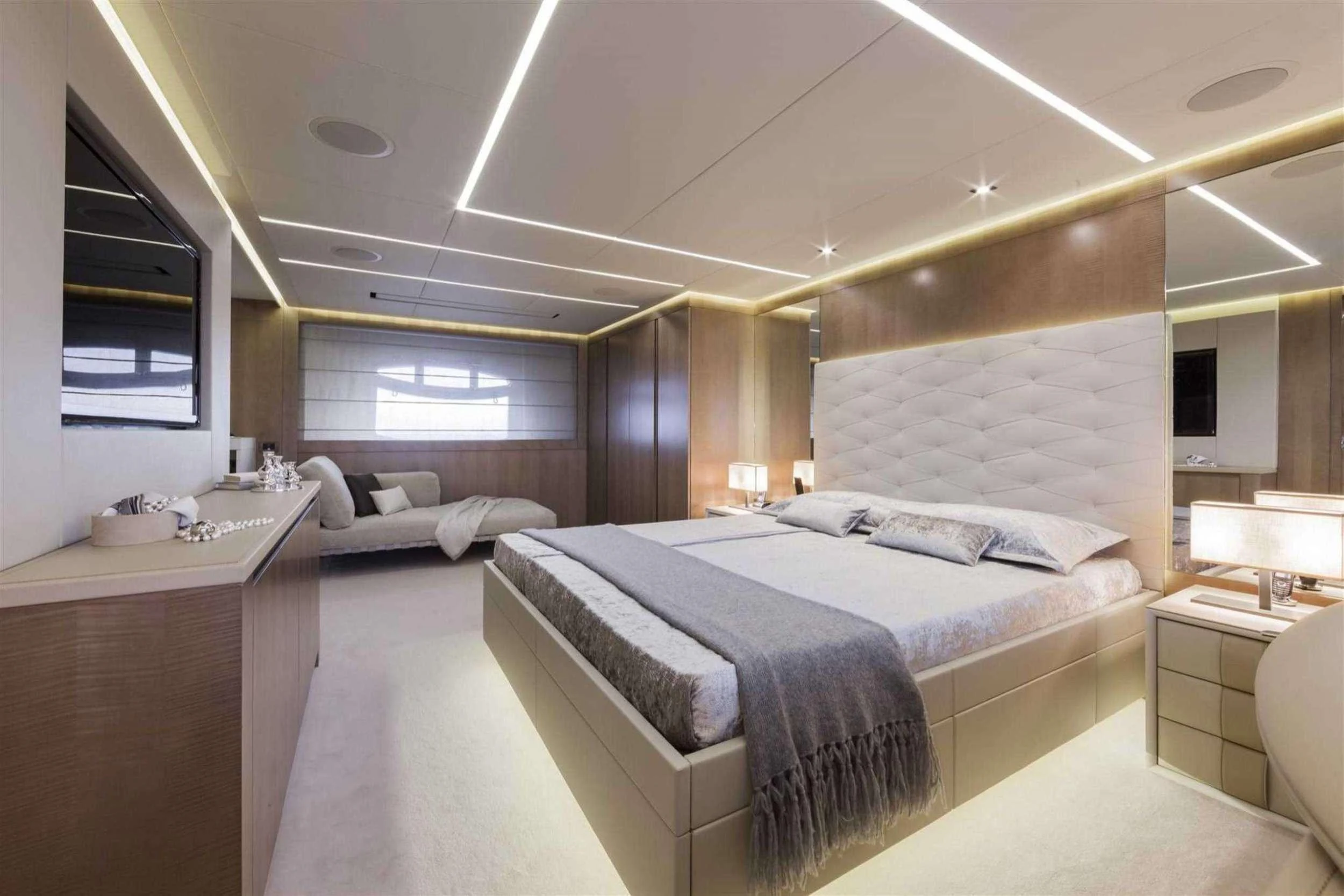 a room with a bed and a desk aboard NAAV Yacht for Charter