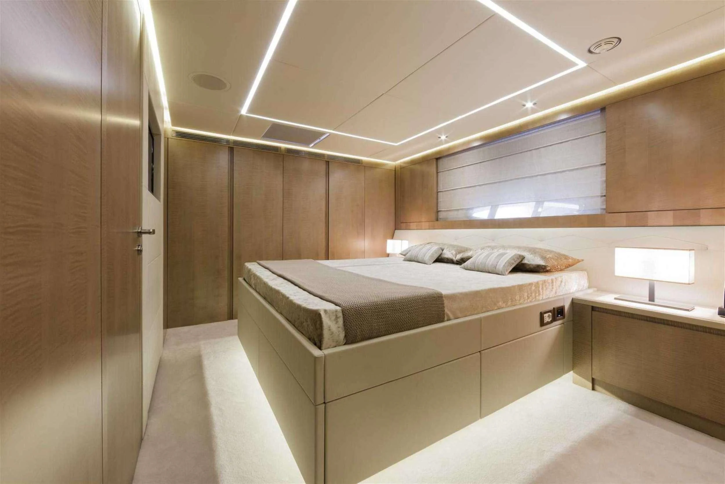 a room with a bed and a desk aboard NAAV Yacht for Charter