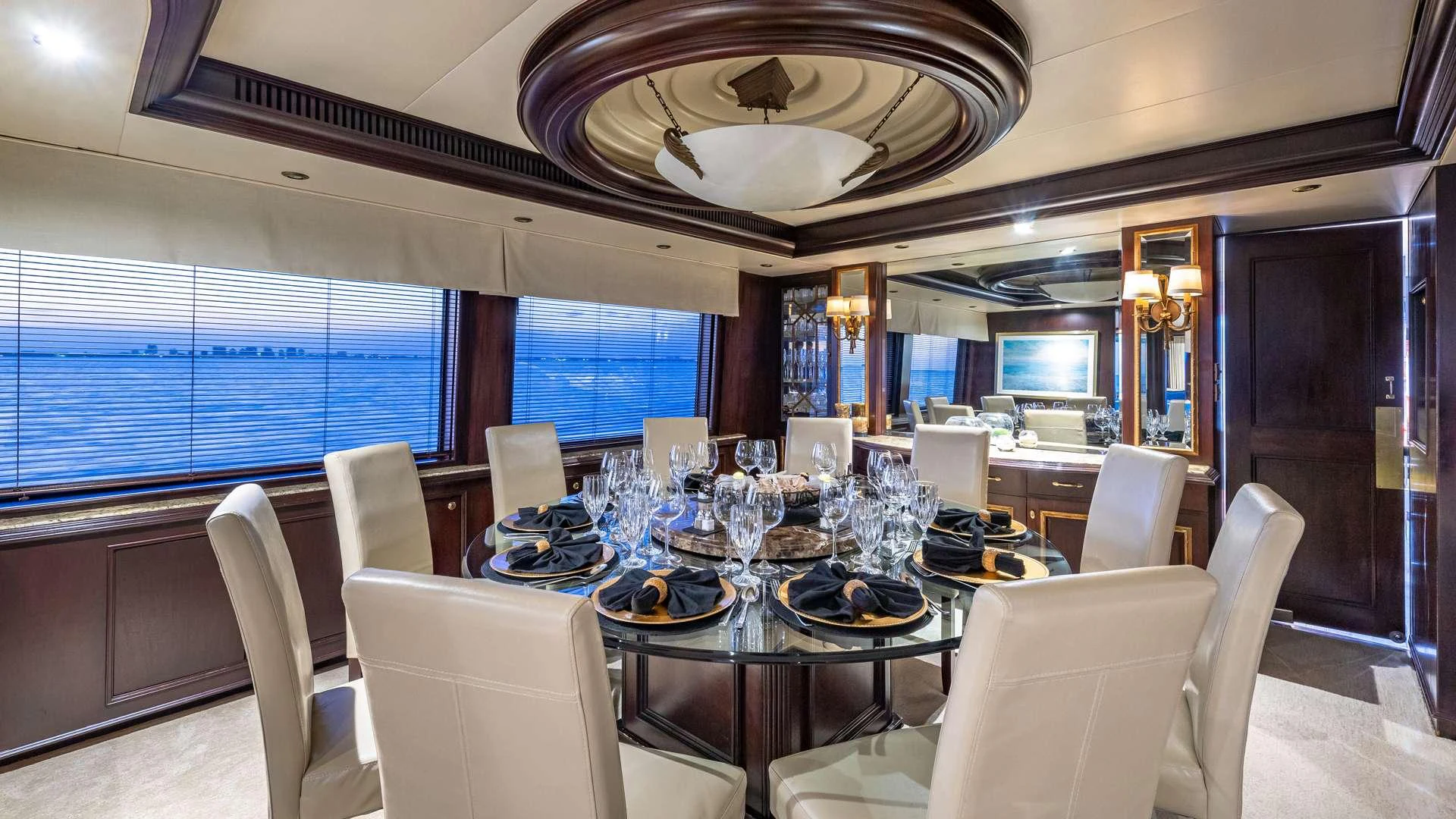 a dining room with a chandelier aboard SEA DREAMS Yacht for Charter