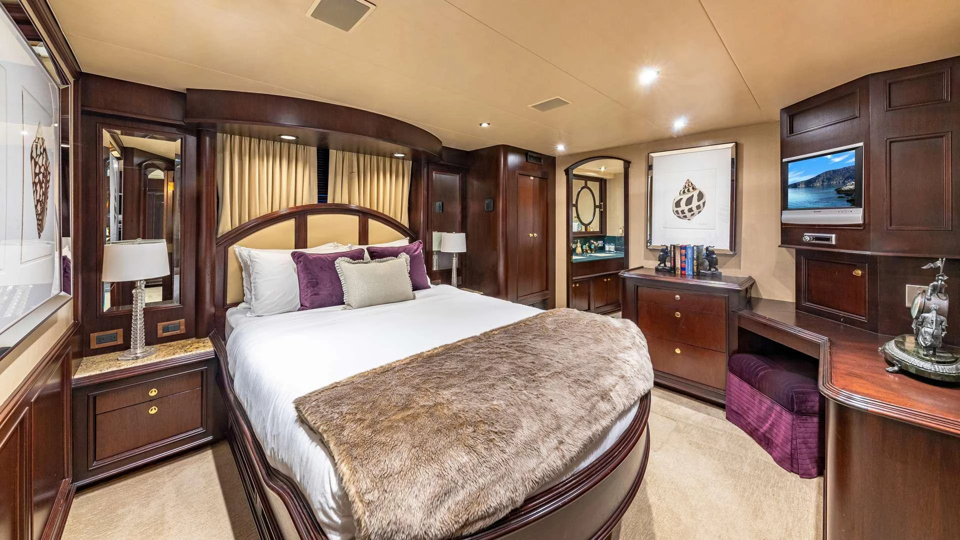a bedroom with a bed and a television aboard SEA DREAMS Yacht for Charter